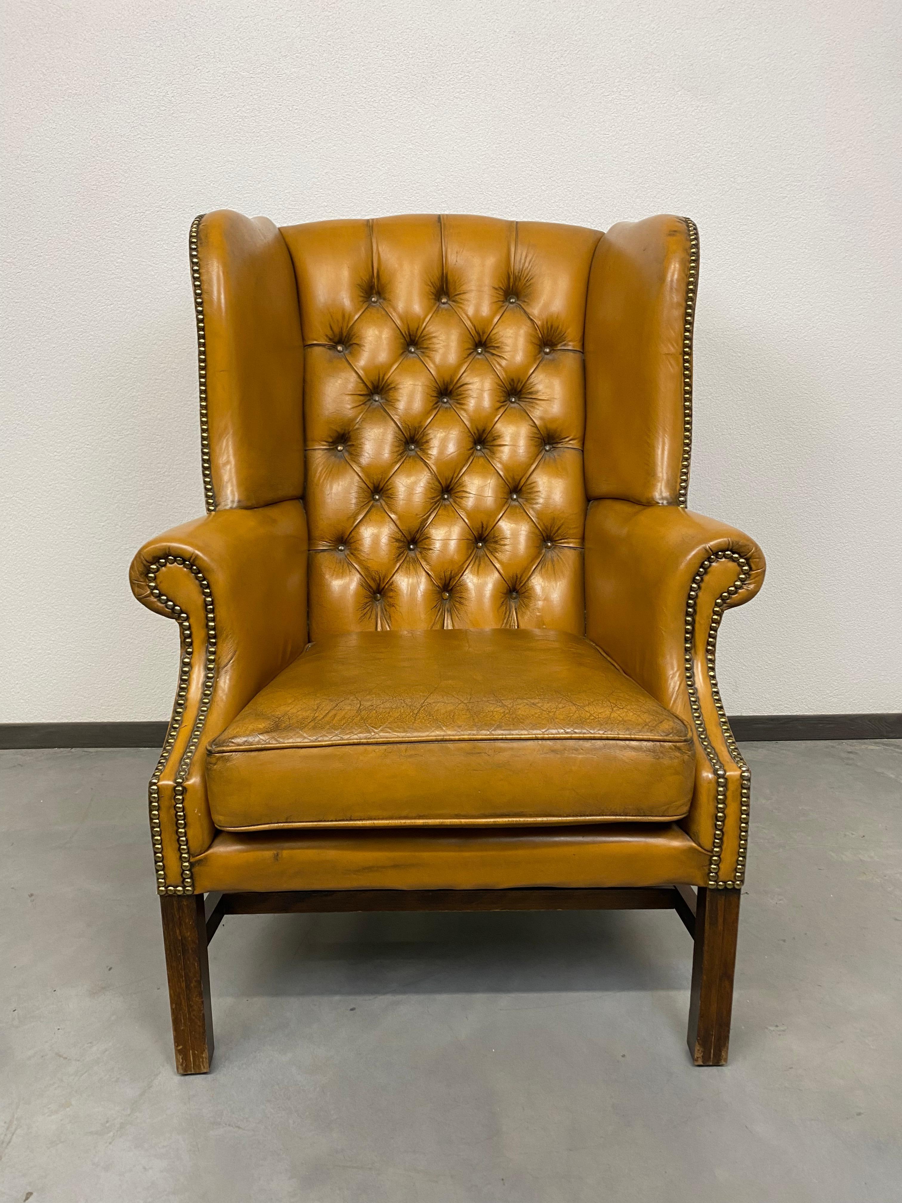 Cigar brown leather Victorian Chesterfield wingback armchair in original vintage condition.
