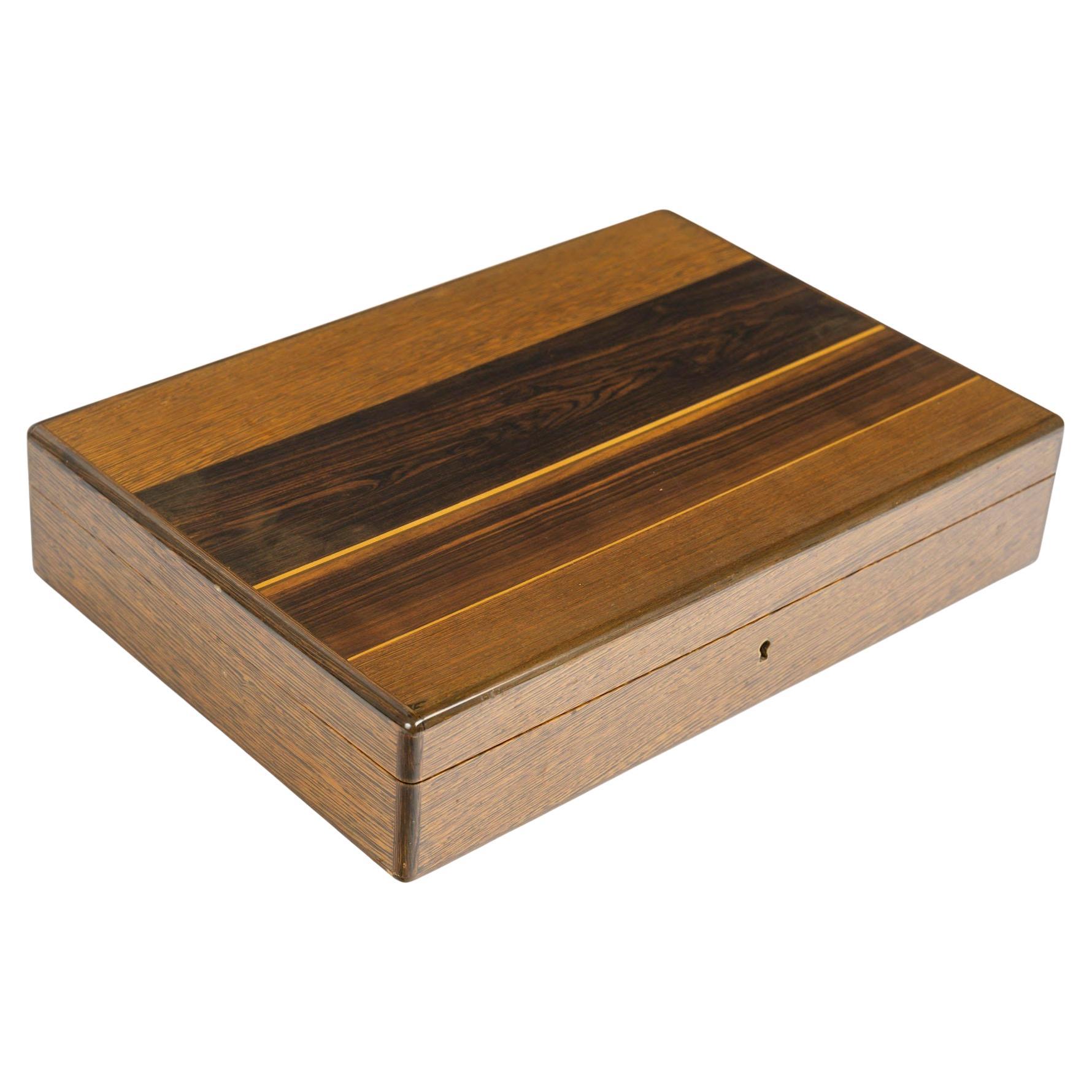 Cigar case, veneered wood, 20th century.

Cigar case, veneered wood, 20th century.
H: 9cm, W: 39cm, D: 27cm