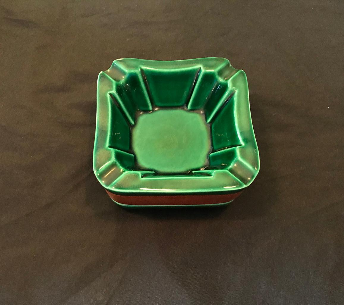 Cigar set by Longchamps in Adnet style, in green faience ceramics and brown leather composed by 1 ashtray and 1 box and its top.
In a very good general condition.

Dimensions: 
L 10.5cm x l 10.5 cm depth 5.5 cm ashtray
L 10cm x l 10 cm depth