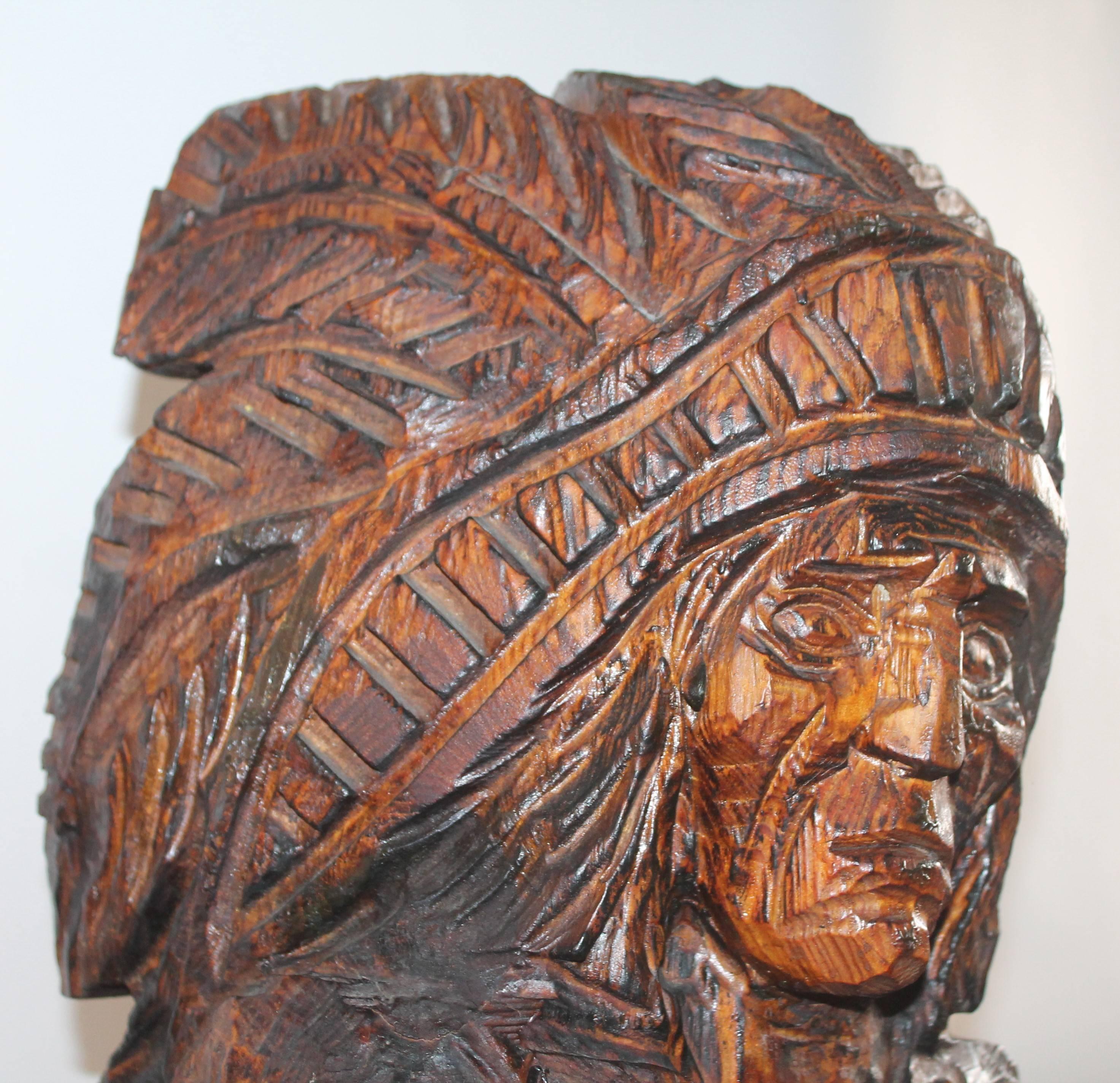 This fine hand-carved counter top cigar store Indian was found in New Mexico and has the original mess bag wrapped around his foot. The condition is good with minor cracks consistent from age and use. It has a wonderful mellow aged patina. Notice