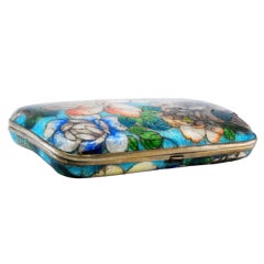 Cigarette case with silver rim and flowers on the lid and fabric interior