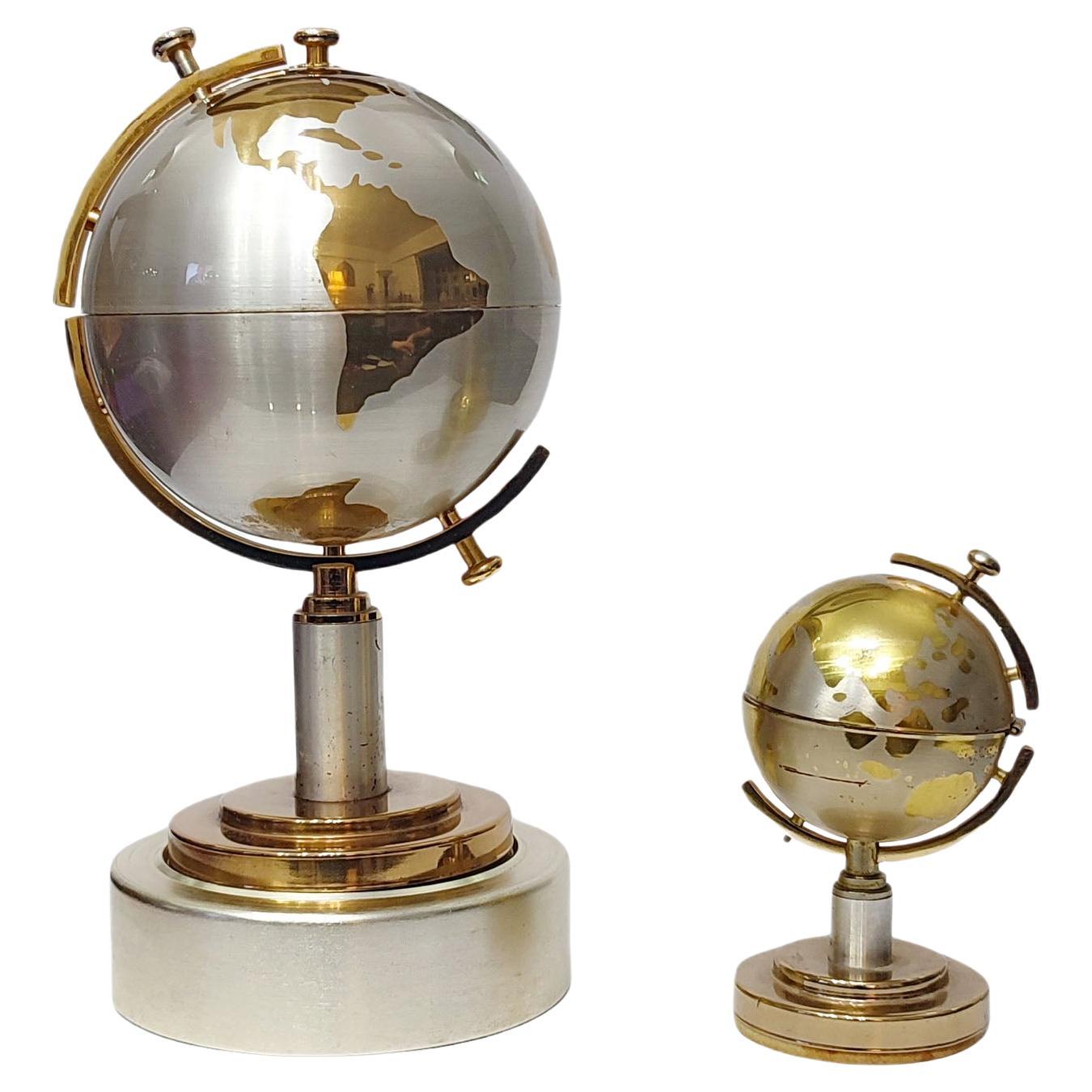 Cigarette Holder Musical World Globe and Globe Lighter, Brass, Germany, 1960s
Decorative tabletop cigarette holder and lighter, spherical form, the decor of the world globe map with polished brass against a satin silver background, cigarette