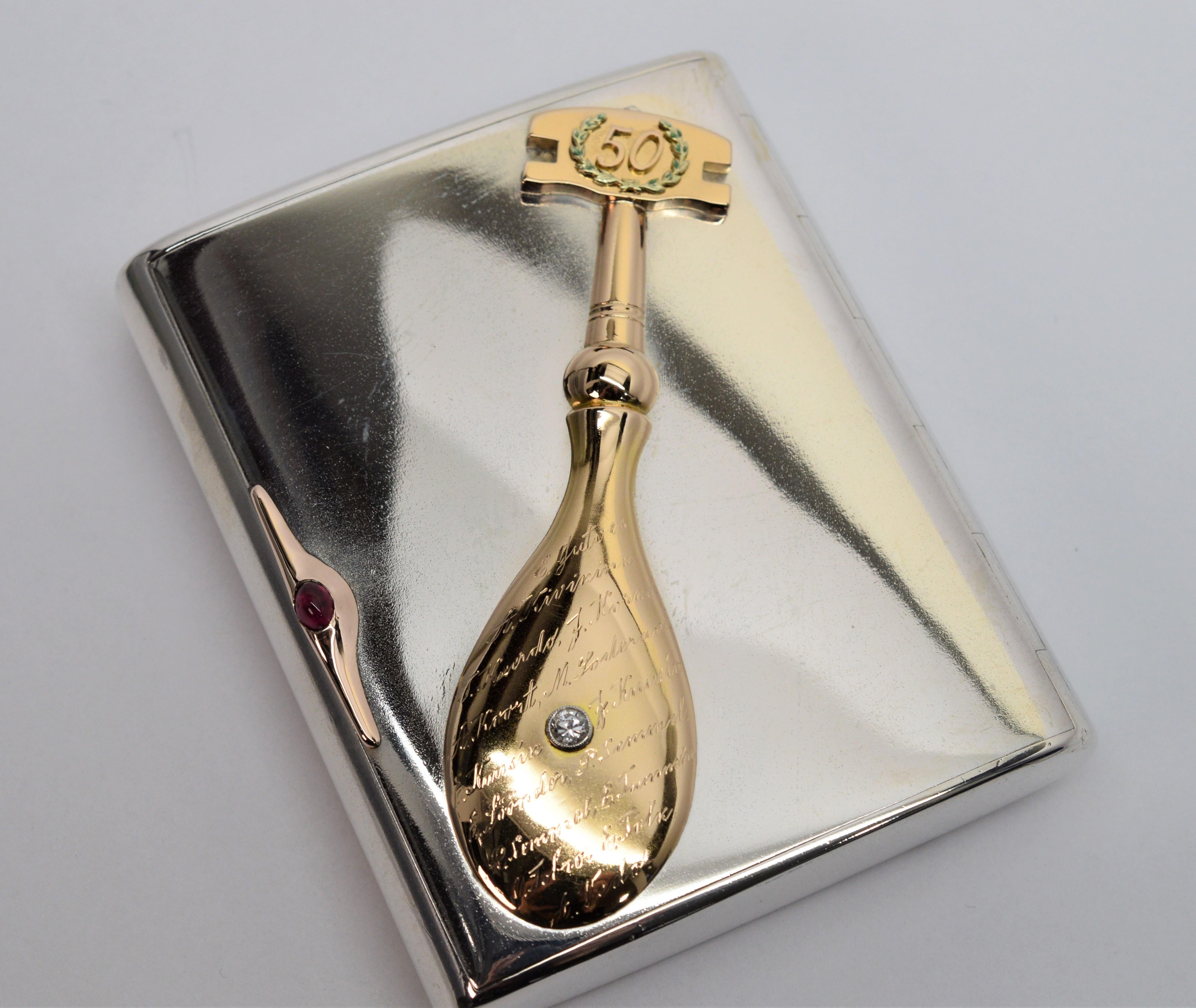 Fabulous one of a kind retro cigarette presentation case, circa 1938, made in Estonia.  With the case made of polished .875 silver, this custom piece displays an unique  scripted ornament of a period glazier's cutting tool in fourteen karat 14k