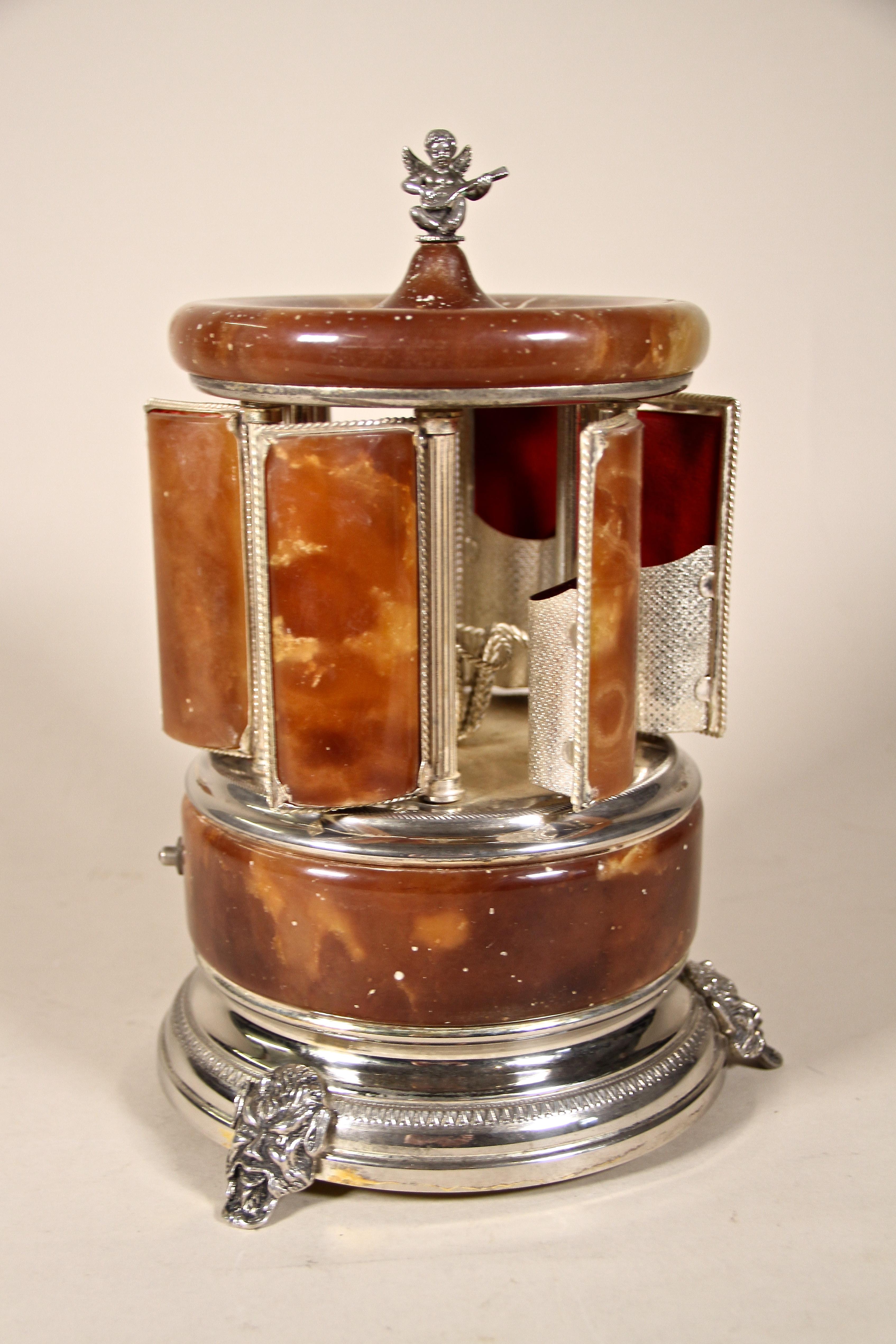 Uncommon cigarette/ cigar holder music box from the mid-century period in Italy around 1960. Beautifully designed as Tempietto with onyx and silvered parts, this exceptional music box carries an amazing secret: when you push the button on the base,
