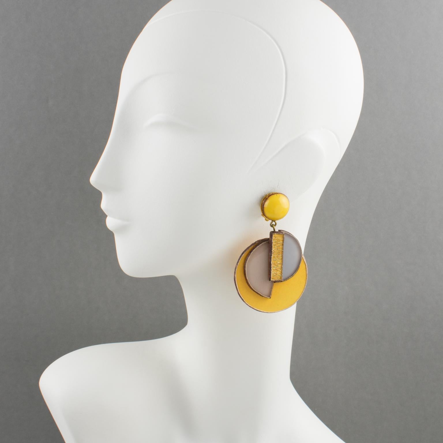 Elegant dimensional dangling clip-on earrings by Cilea Paris. Art Deco revival inspired hand-made artisanal resin earrings featuring assorted geometric forms with textured patterns to build together and form a powerful statement piece. Very nice