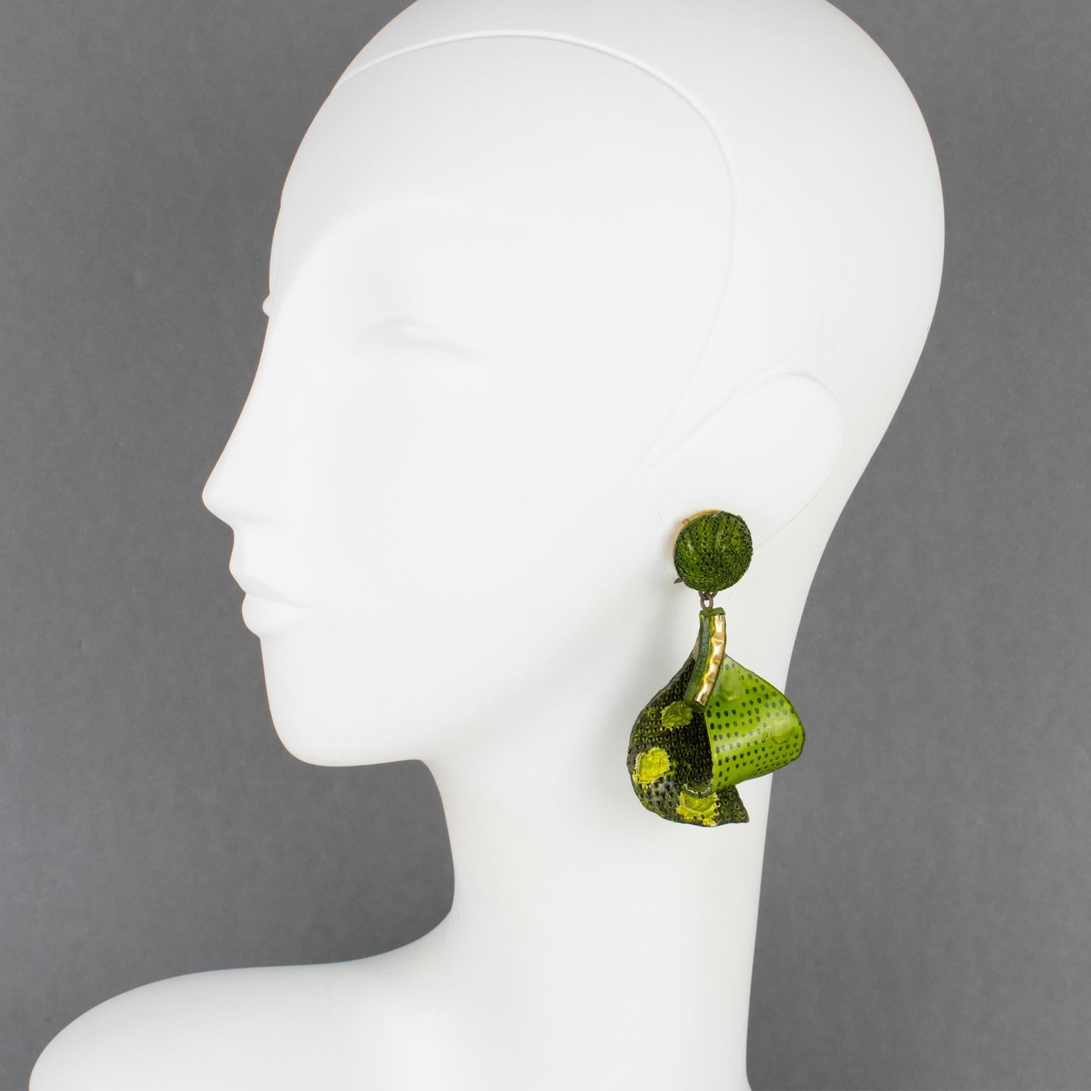 Elegant dimensional dangling clip-on earrings by Cilea Paris. Floral and geometric-inspired hand-made artisanal resin earrings featuring large leaves with textured patterns built together to form a powerful statement piece. A very nice assorted