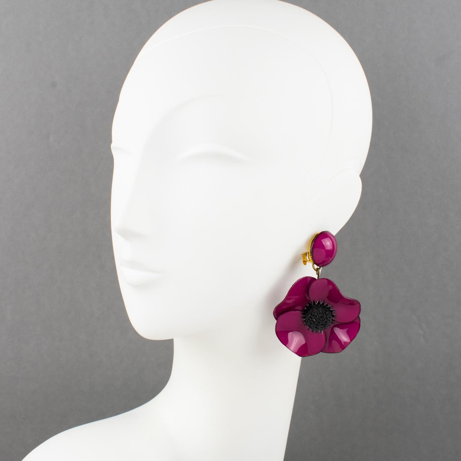 Cilea Paris designed these romantic dimensional dangling clip-on earrings. These oversized floral-inspired hand-made artisanal resin earrings feature poppy flowers with textured hearts built together to form a powerful statement piece. Very nice