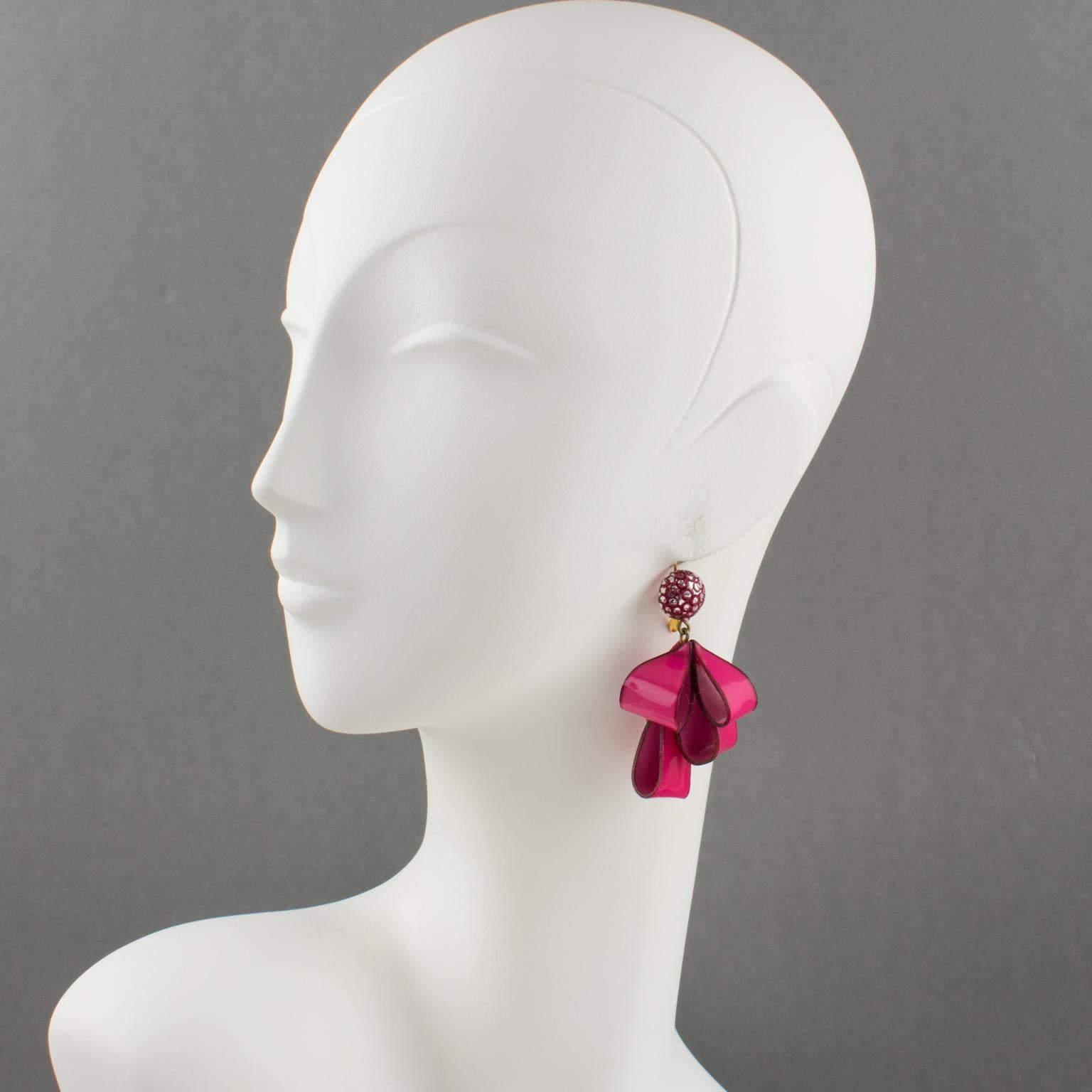 Adorable dimensional dangling pierced earrings by Cilea Paris. Hand-made artisanal resin or Talosel earrings featuring dimensional ribbon with textured patterns build together to form a powerful statement piece. Very nice vivid hot pink and silver