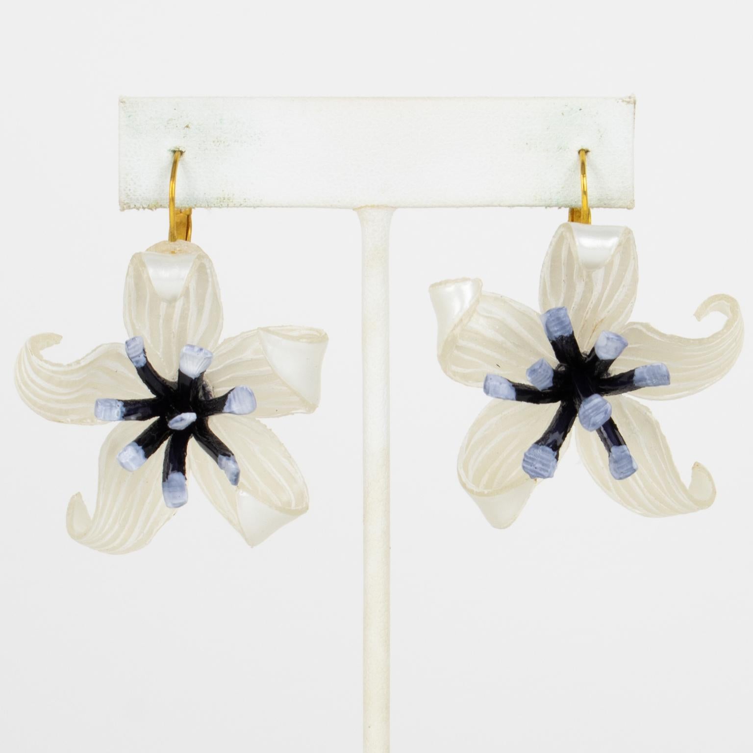 Cilea Paris designed these adorable dimensional dangling pierced earrings. These hand-made artisanal resin earrings feature dimensional flowers with textured patterns built together to form a powerful statement piece. They are adorned with arctic