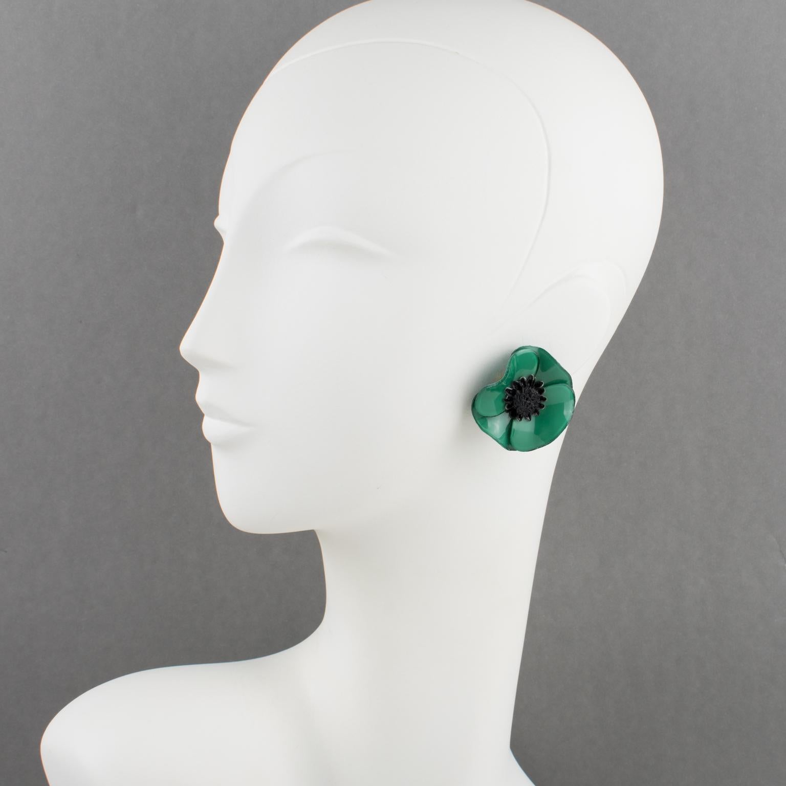Elegant dimensional clip-on earrings by Cilea Paris. Floral-inspired hand-made artisanal resin earrings featuring a large poppy flower with a textured heart. A very nice assorted palette of peacock green and black. Signed underside: Cilea - Paris.
