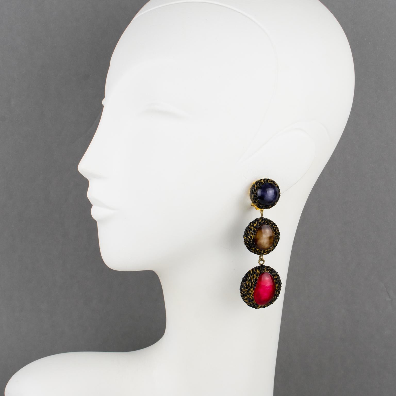 Lovely dimensional dangling clip-on earrings designed by Cilea Paris. The long graduated shape is composed of geometric resin elements topped with braided textured patterns and three colored cabochons. These different elements build together to form
