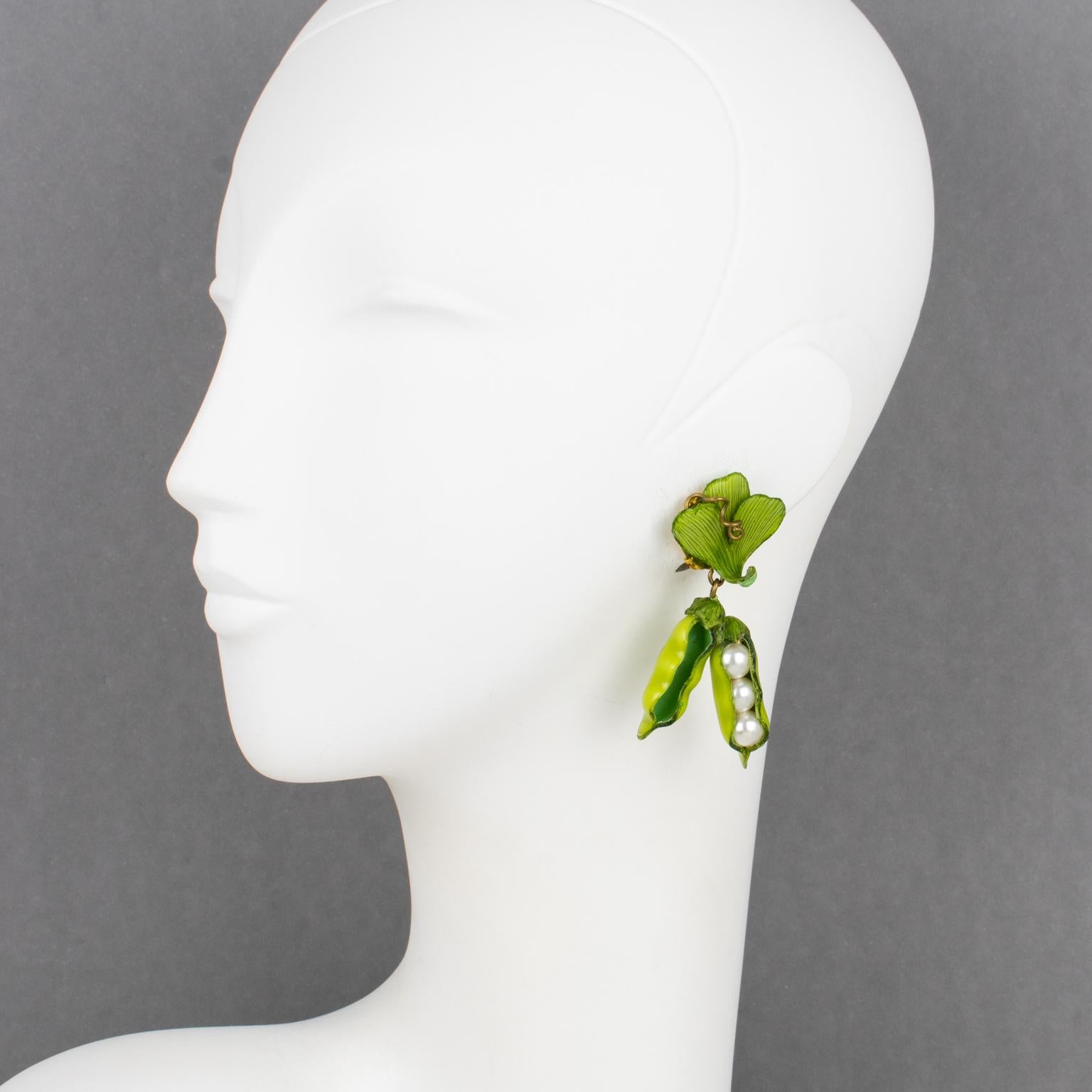 Cilea Paris created these cute, dangling resin clip-on earrings. They feature a dimensional dangle of green peas with pea pods and leaves in a fresh green color. The peas are in pearl-imitation beads. The pieces are marked on the underside with the