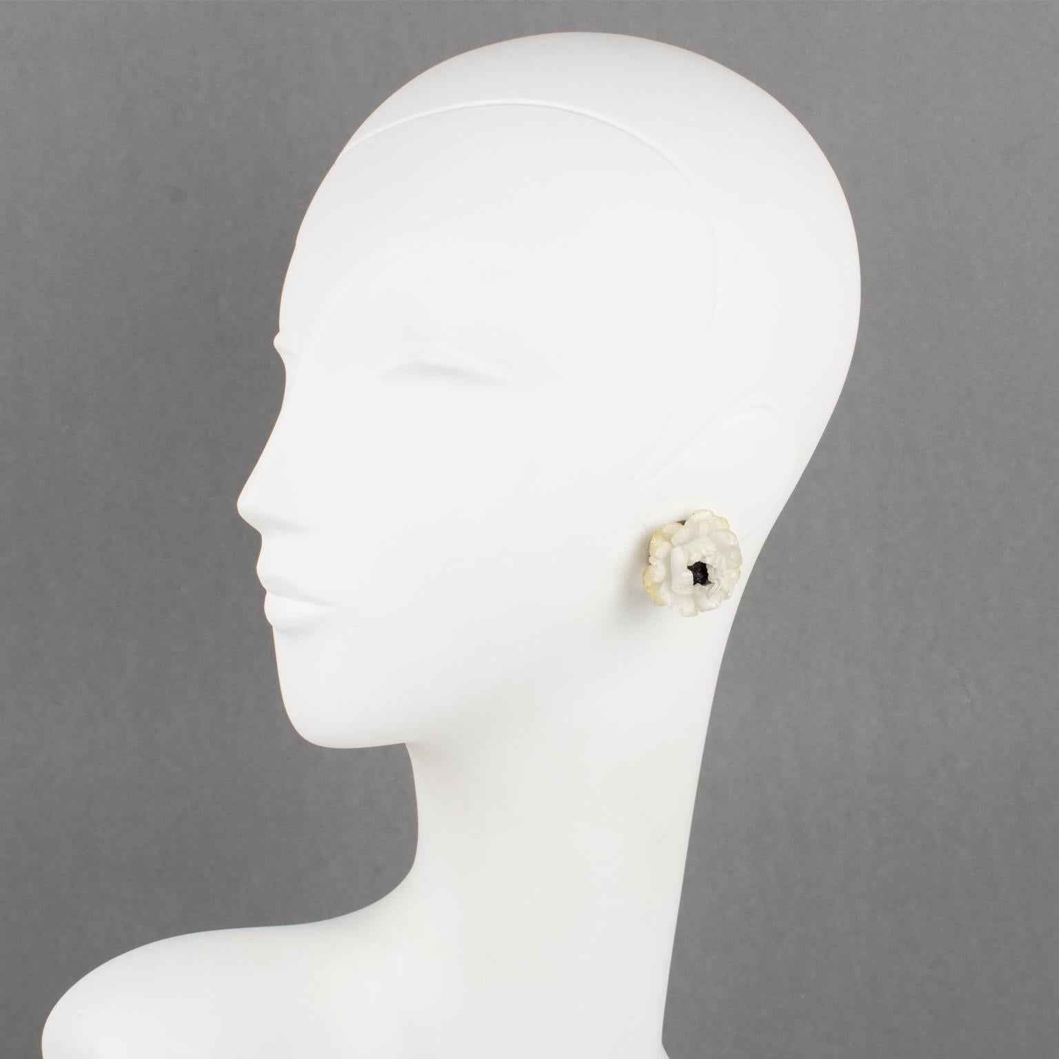 These lovely dimensional clip-on earrings, designed by Cilea Paris, feature a floral-inspired hand-made artisanal resin composition in a rose flower with a textured heart. A classic off-white color with light yellow overtone edges contrasted with a