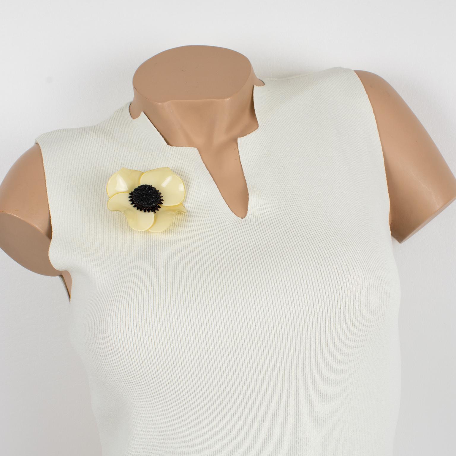 This lovely resin brooch by Cilea Paris boasts a floral-inspired, hand-made artisanal shape. The resin lightweight pin features a massive dimensional poppy flower with a textured heart, pale yellow butter, and black colors. The signature is on the