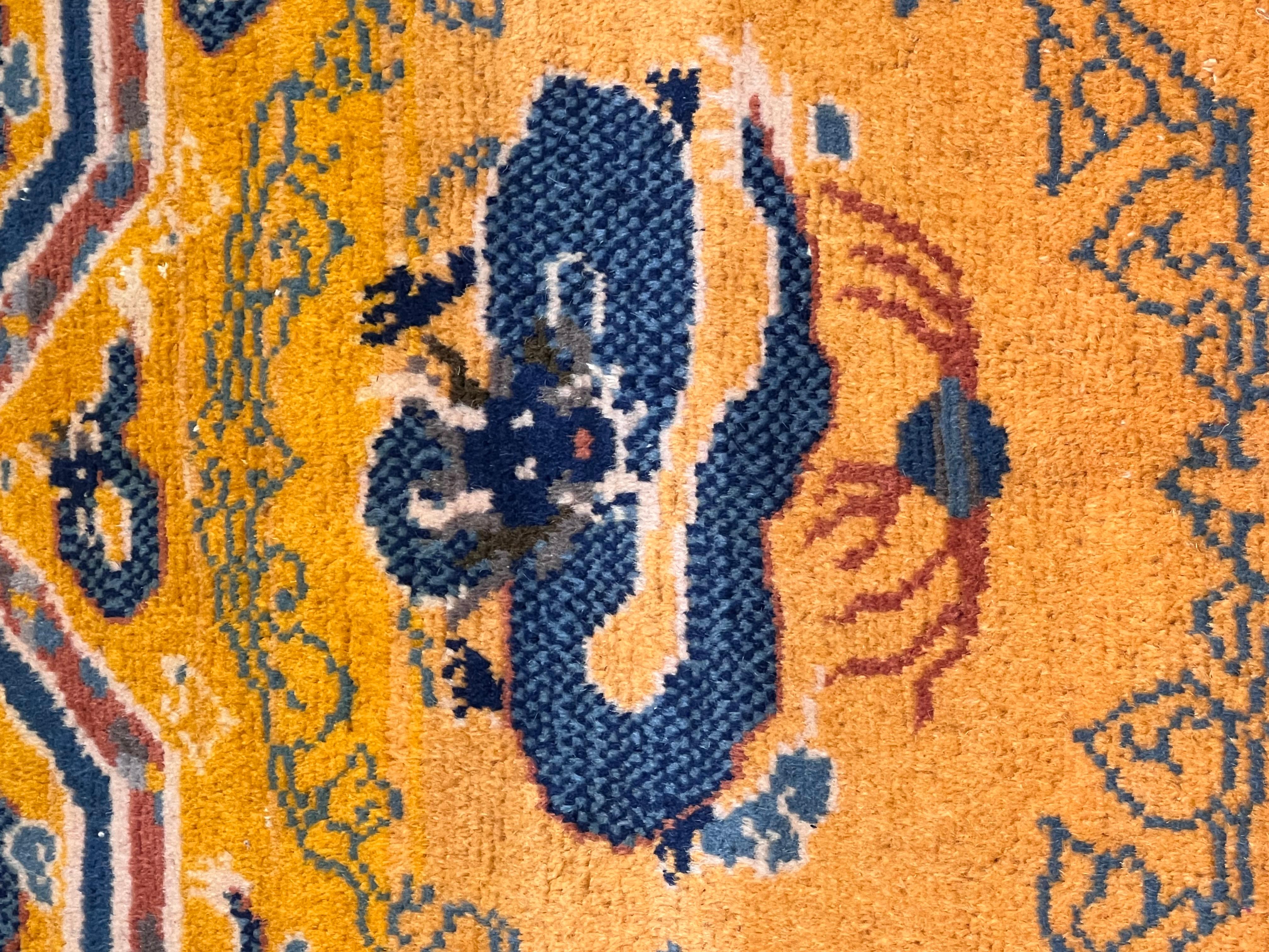 Peculiar and at the same time characteristic is the decoration of this old Chinese carpet with a rare orange background. Main element is the eight-pointed star, used in Buddhist culture as a symbol to represent the entire cosmos.
Eight is