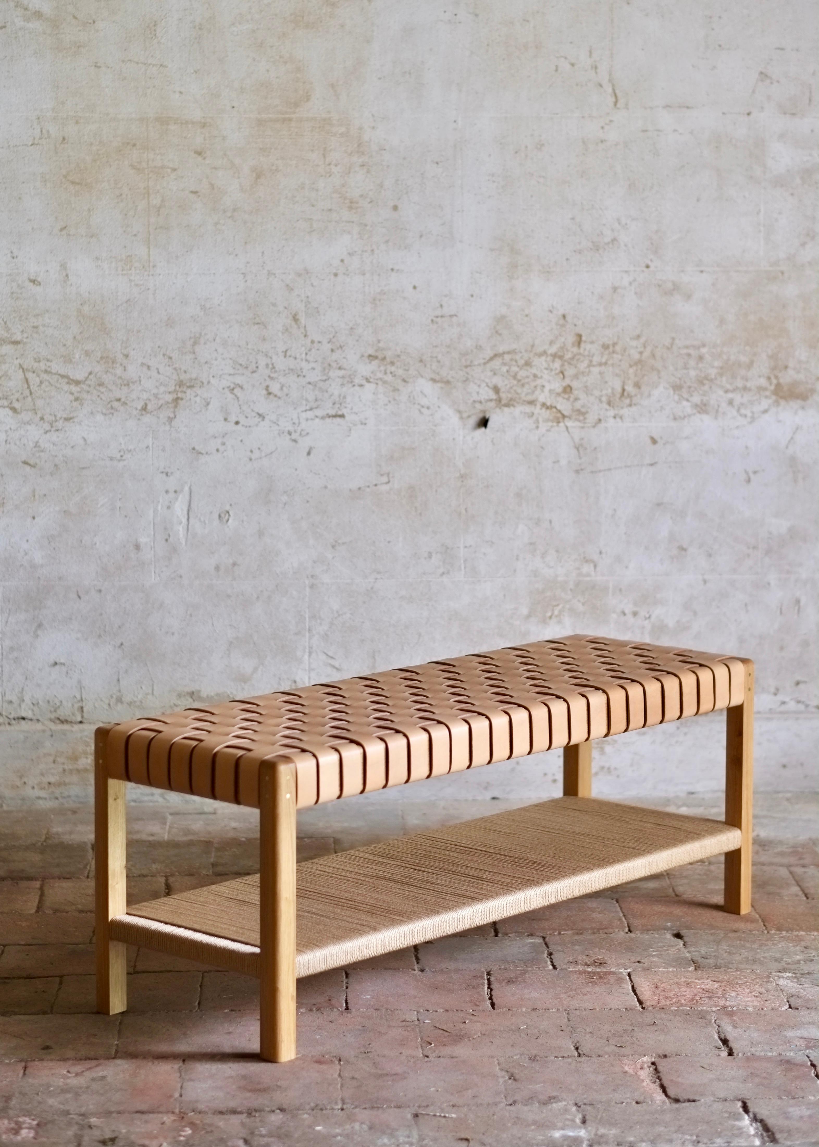 Inspired by the utilitarian and timeless minimalism of the Shaker tradition, the Cinch bench fuses traditional timber frame joinery and classic leather working techniques. Shaped legs and pinned tenon joints are paired with woven oak bark tanned