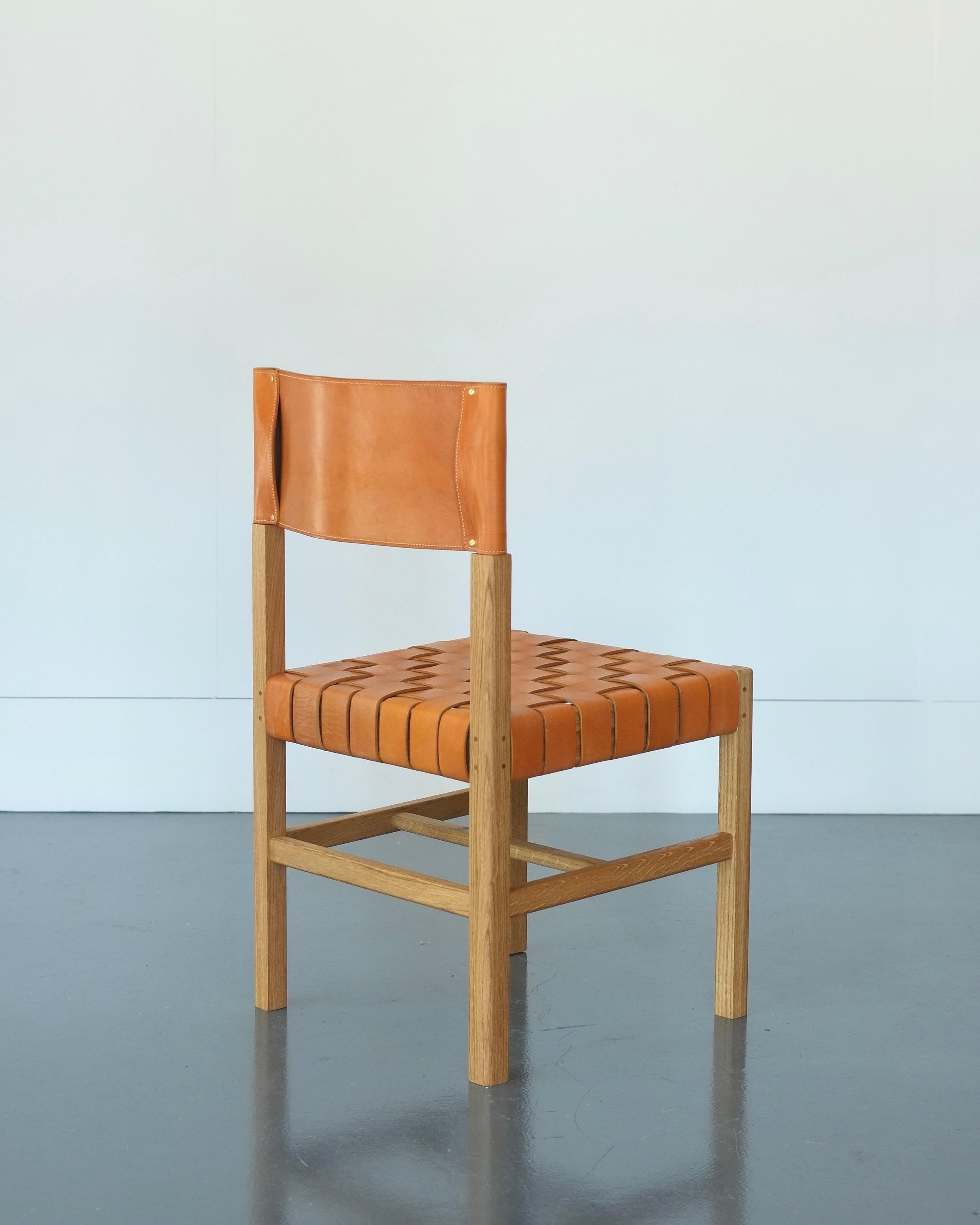 Inspired by the utilitarian and timeless minimalism of the Shaker tradition, the Cinch dining or occasional chair fuses traditional timber frame joinery and classic leather working techniques. Hand turned back legs and pinned tenon joints are paired