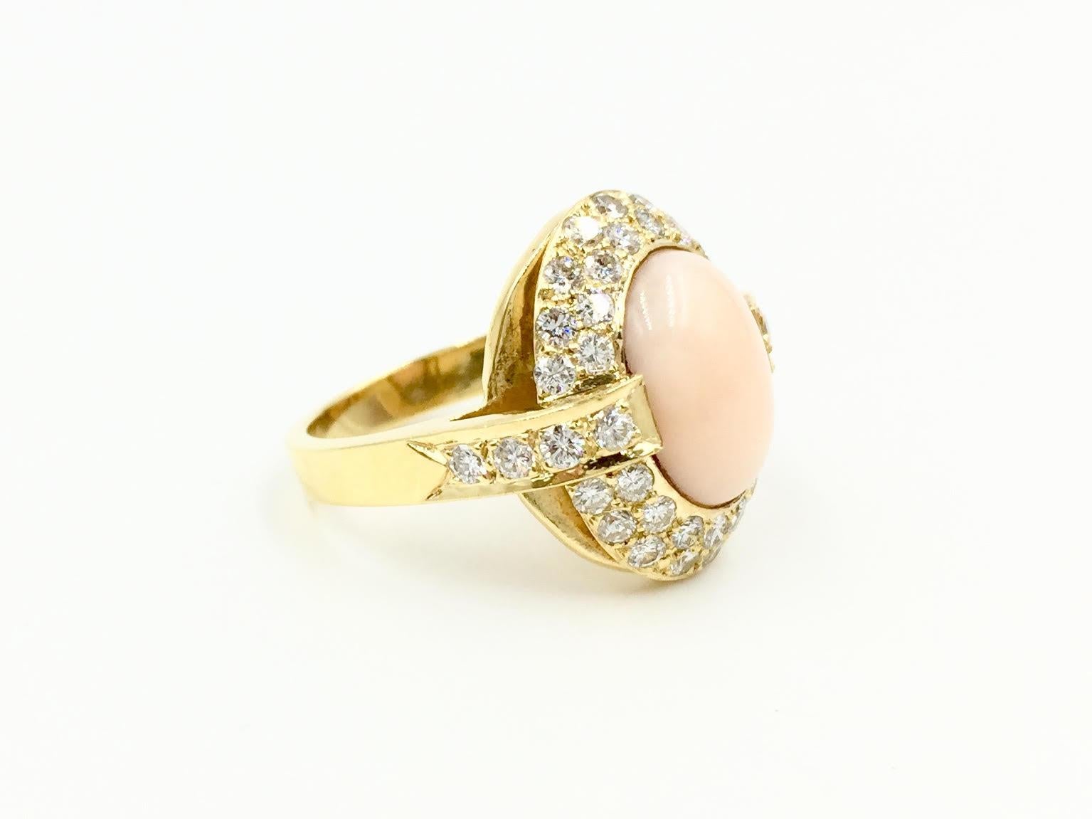 An incredible find, this Cindy Royce ring features genuine light pink coral beautifully surrounded by two rows of pavé set bright, clean round brilliant diamonds with a diamond carat total weight of 1.10 carats. With a nice low profile, this ring is