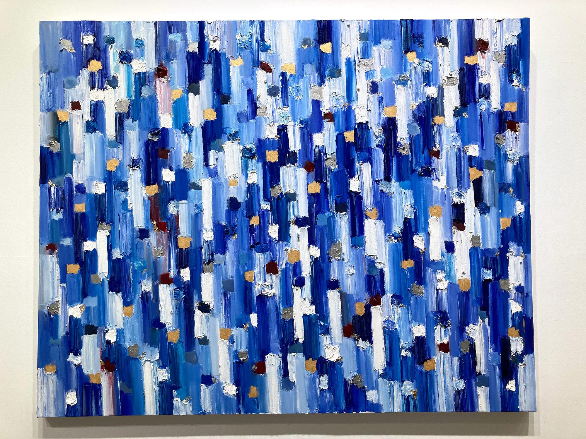 With layers of bright oils and whisking brush strokes, the paint is able to shine and shimmer in a very unique pattern. The artist uses gold leaf with thick textured oils and glass to add a very contemporary, urban feel. The “Dripping Dots” cascade