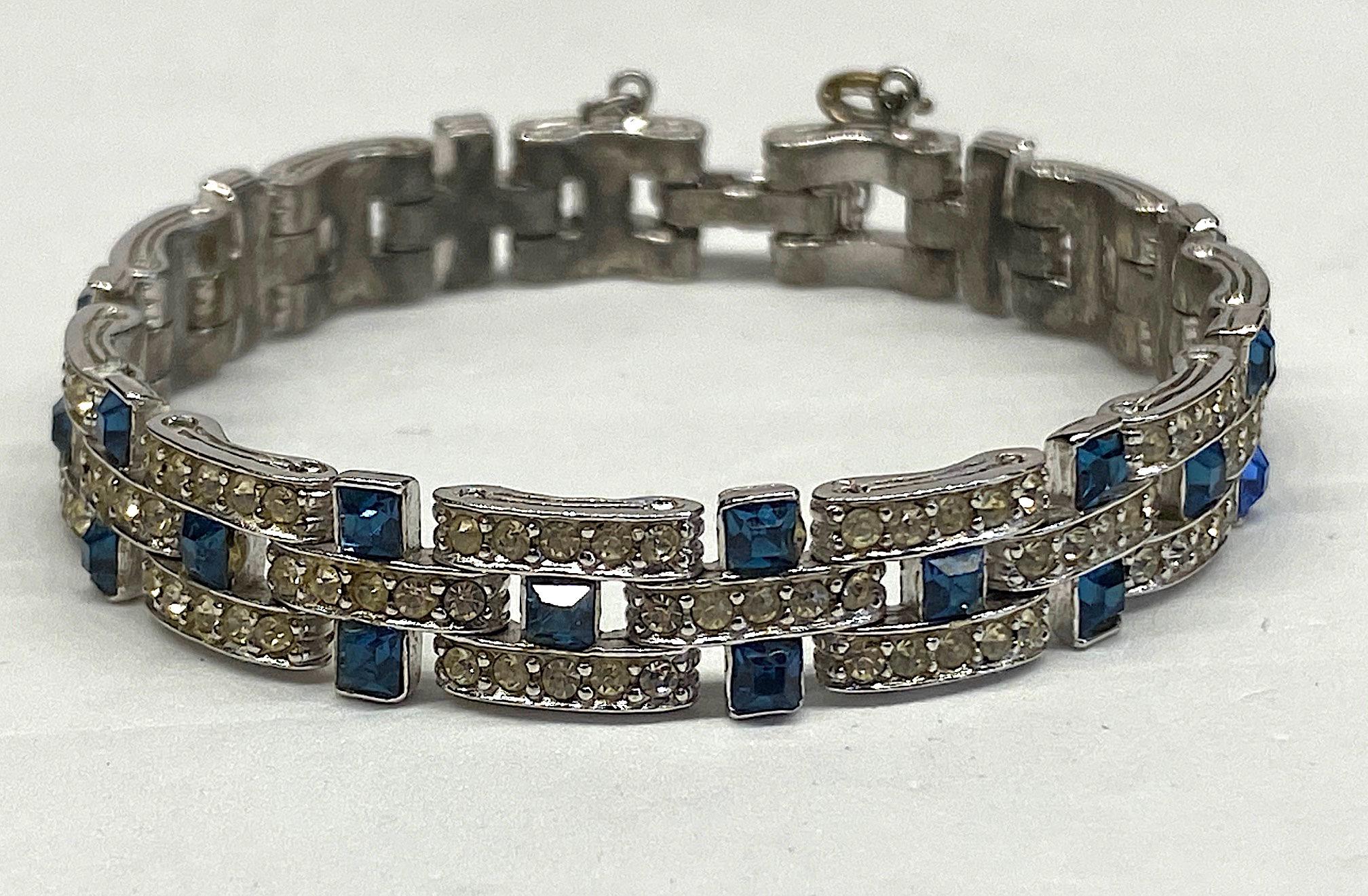 An early 1930s Art Deco bracelet by New York City fashion jewelry company Ciner. The bracelet is rhodium plate with geometric design typical of the Art Deco style of the day. The links alternate between ones shaped like an H and ones shaped like an