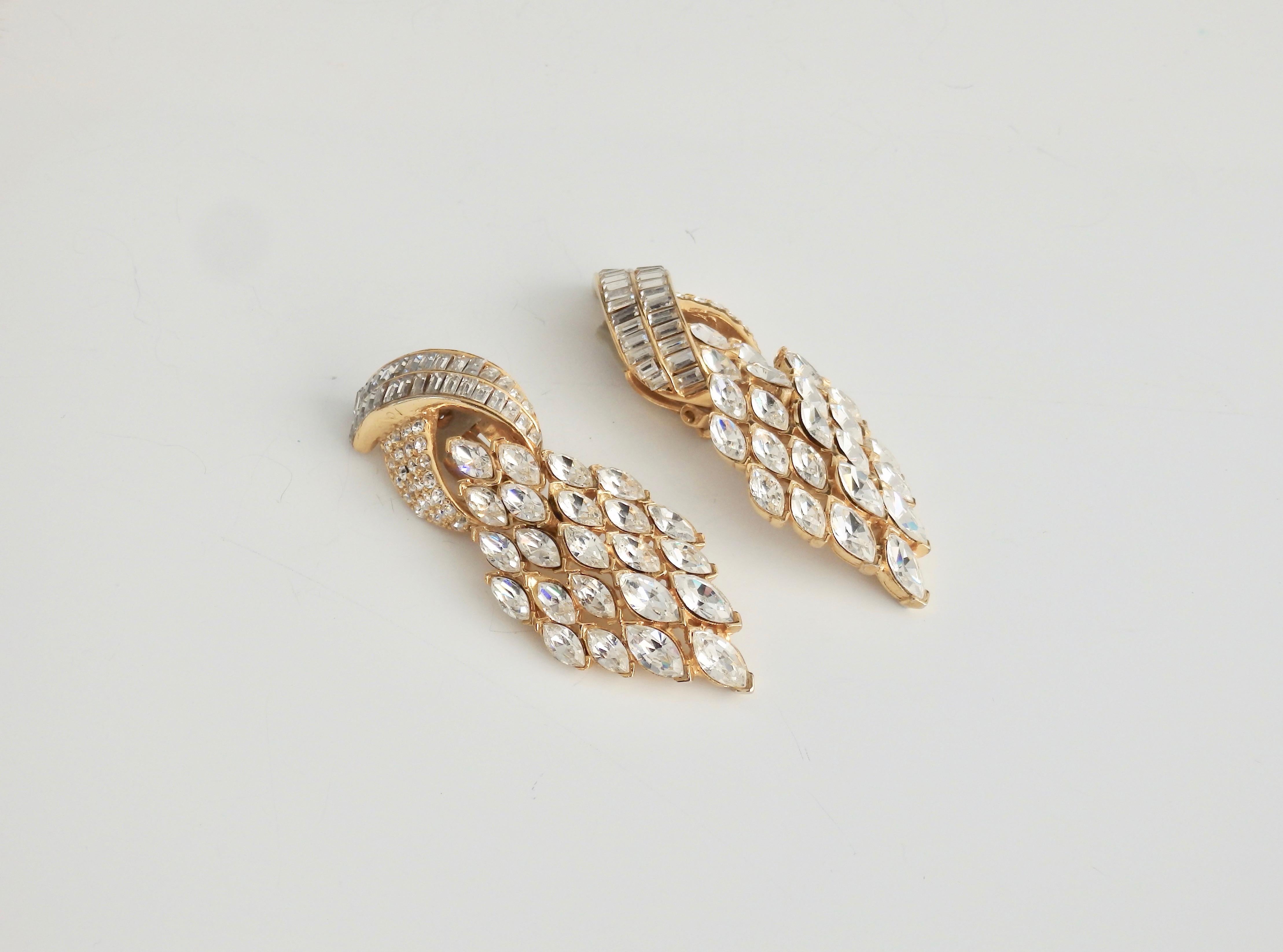 Swarovski crystals make these stunning and gorgeous statement earrings perfect for that glamorous look. Vintage 1980s punch with Art Deco timeless style. Gold plated white metal (the Ciner family business became known for perfecting the use of white