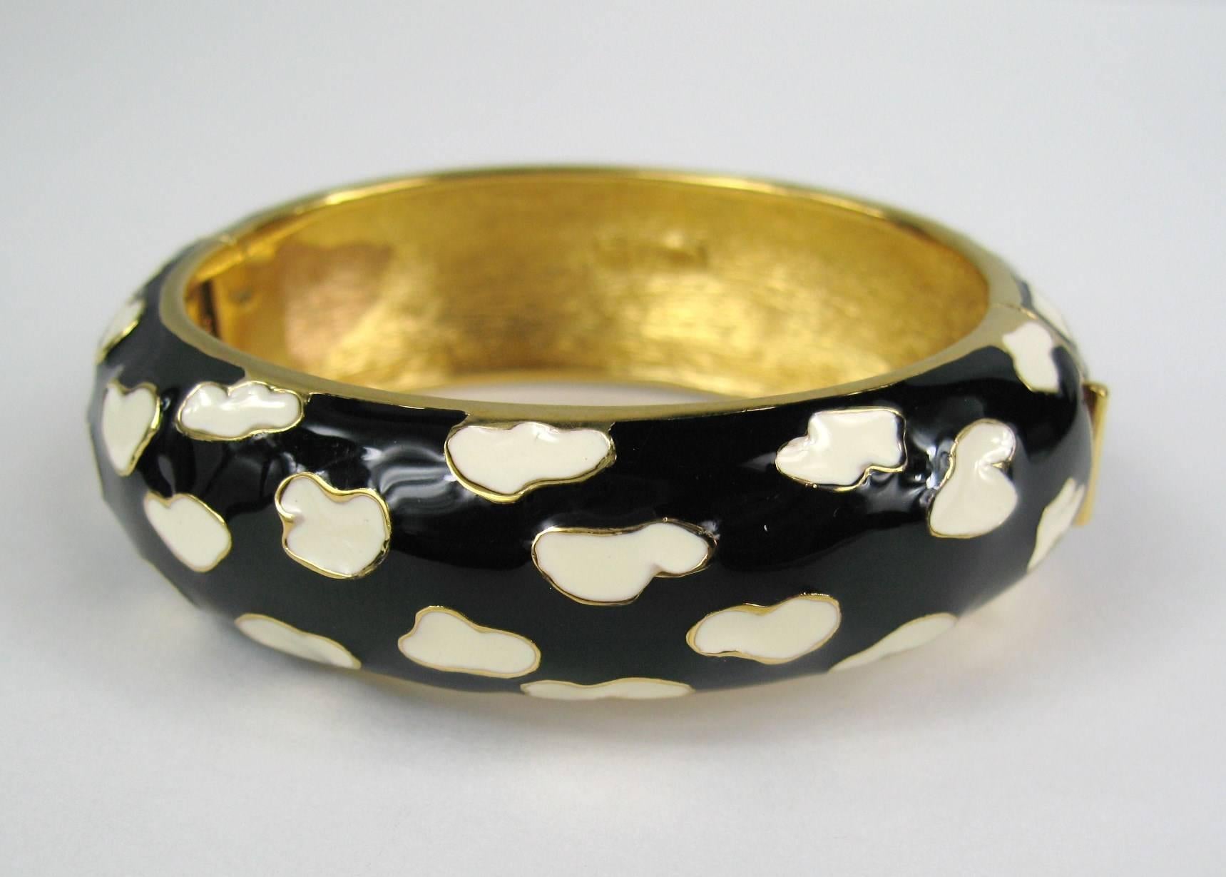 Ciner black and white enameled bracelet. Hinged and has a slide in clasp. Measures .80 inches/ Will fit a 6.5-7.5 wrist nicely, depending on how loose you want it. We have the matching earrings listed on our storefront as well. We have many matching