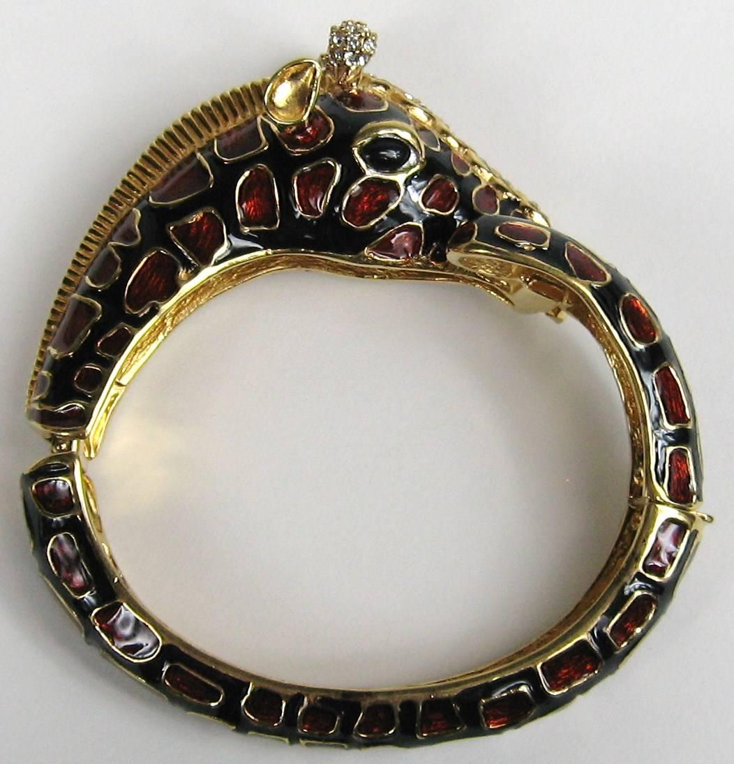 Ciner Giraffe Rhinestone Enamel Bracelet Has a gold-toned base with black enamel, Swarovski Crystals adorn this bracelet. Will fit a 6-7 wrist nicely. Inside measures 7 inches. This still has the tags from Neiman Marcus. We have more Ciner jewelry