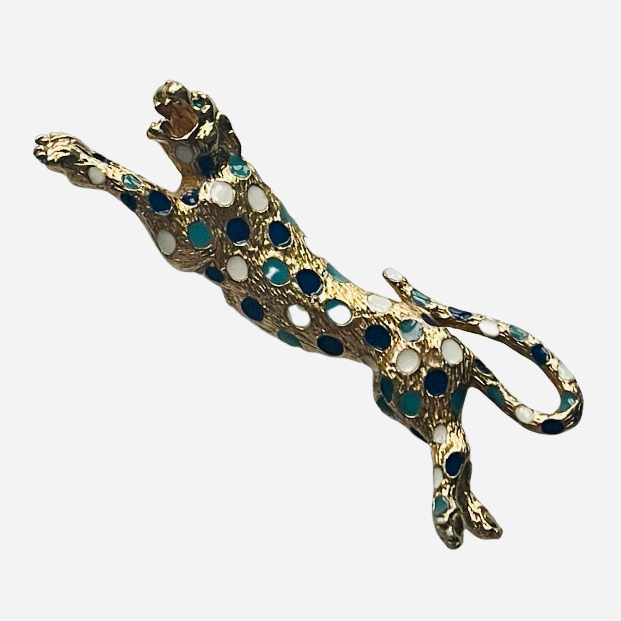 Crafted by renowned costume jeweler Cinar, this cast-metal enamel gold-tone leopard pin features rich enamel markings and glass green gem eyes.  

This unique pin was hand-painted! Creating this beautiful piece of wearable art! 

The condition of