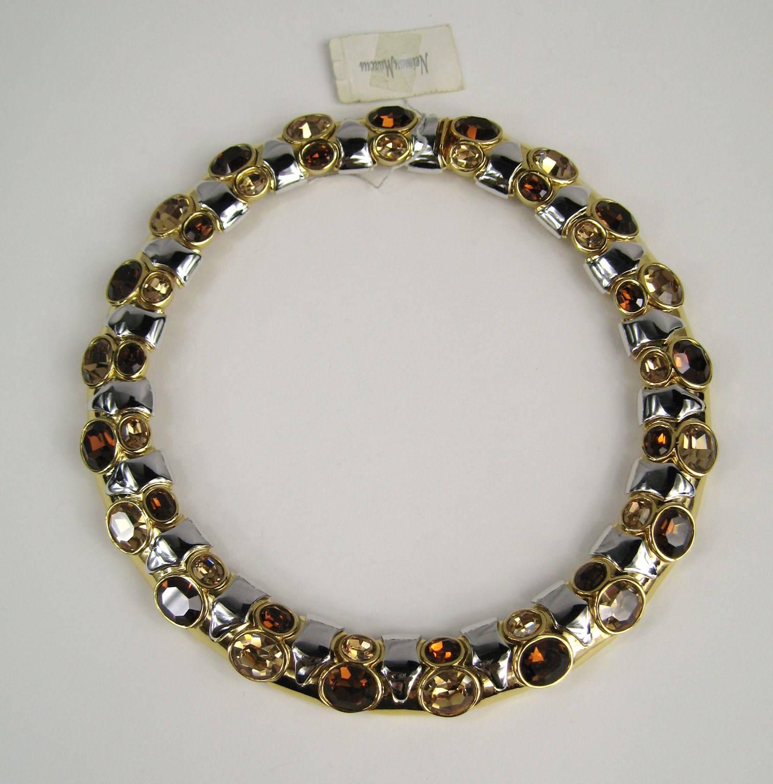 Stunning Ciner Necklace purchased in the late 1980s. Large Facated stones in a white & yellow Gold tone Gilt. Price tag still attached from Neiman Marcus. Measuring .75 in. wide x 17 in. New Old Stock, never worn. This is out of a massive collection