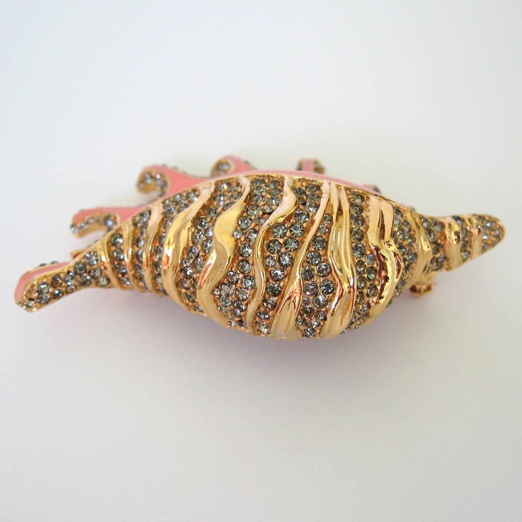 Ciner Conch Shell Enamel Brooch set with Swarovski Crystals. Large Fabulous Shell Brooch. Has Salmon colored enamel inside the shell with Pave set Swarovski Crystals all over this piece. The Neiman Marcus price tag still attached. This Measures 2.95