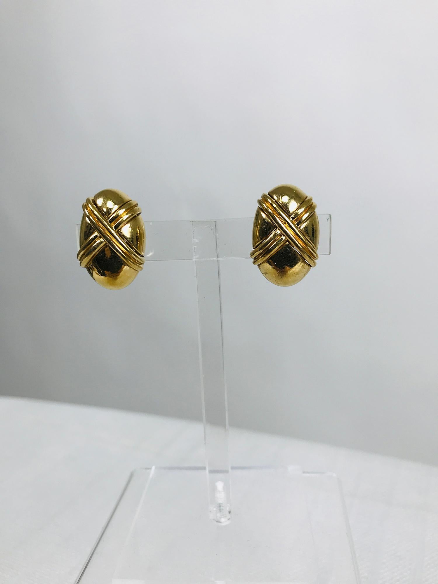 Ciner gold metal oval earrings with double X on each earring, classic style. Beautiful three dimensional earrings have raised sides. In excellent condition. Approximately 1