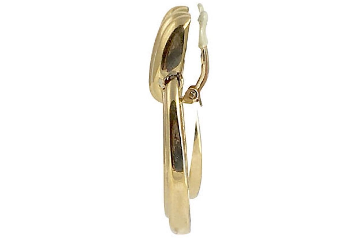 Large Ciner statement door knocker clip-back earrings featuring a ribbed goldtone design. Signed 