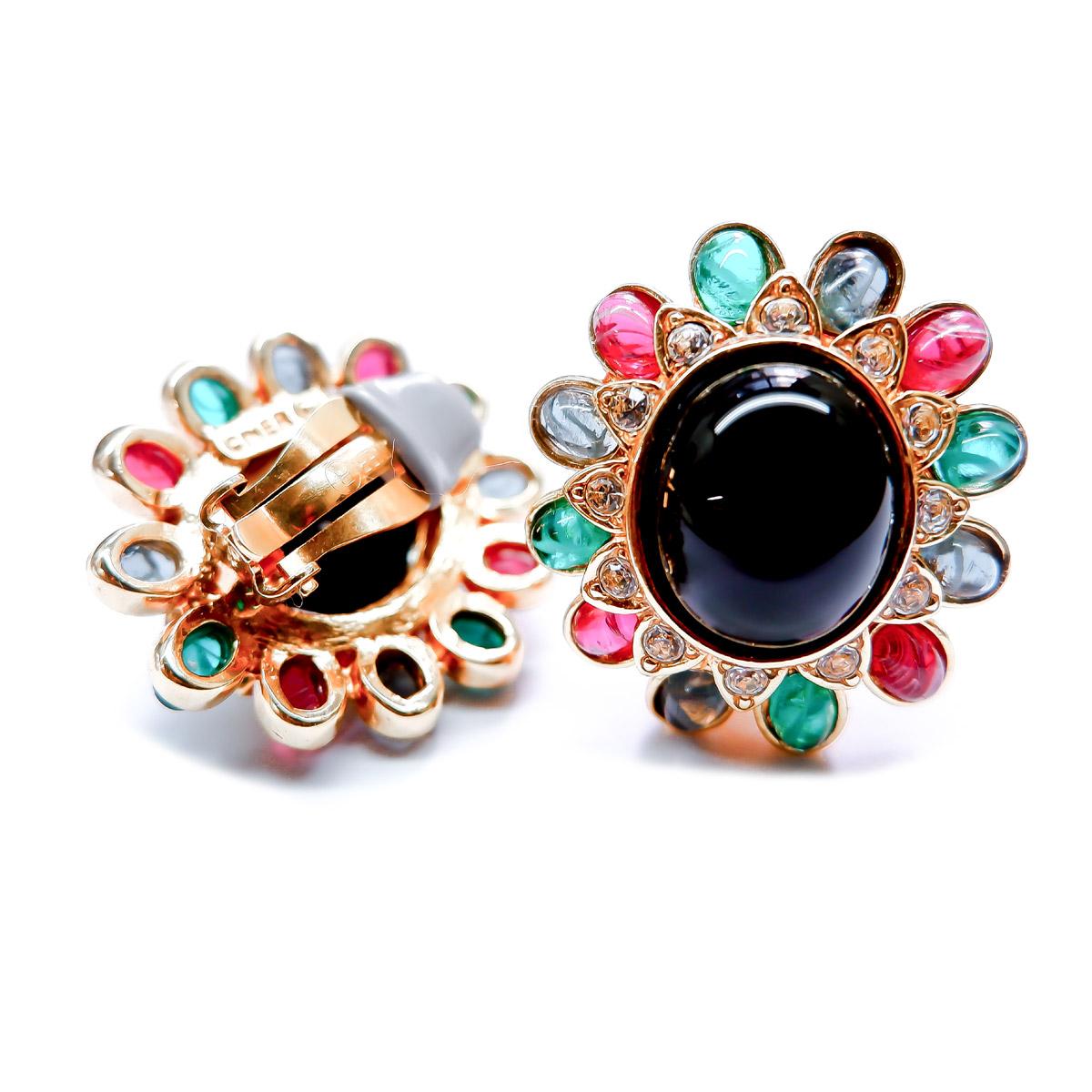 These gorgeous clip earrings have a ruby, emerald, sapphire cabochon trim with a stunning jet cabochon center. These earrings will add the perfect amount of vintage charm to any ensemble. 
Materials:
Pewter
18K Gold Plating
Sapphire Cabochons
Ruby