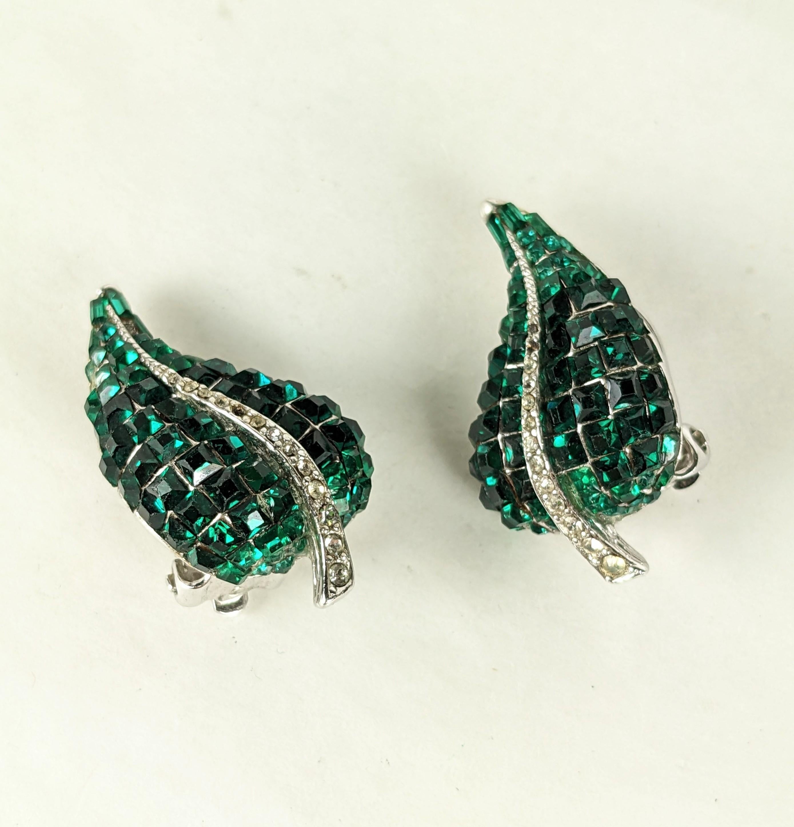 Elegant Ciner Invisibly Set Emerald Earrings with clip back fittings. Set with vari sized emerald pastes of different sizes throughout on rhodium metal. 
1980's USA.  1.25
