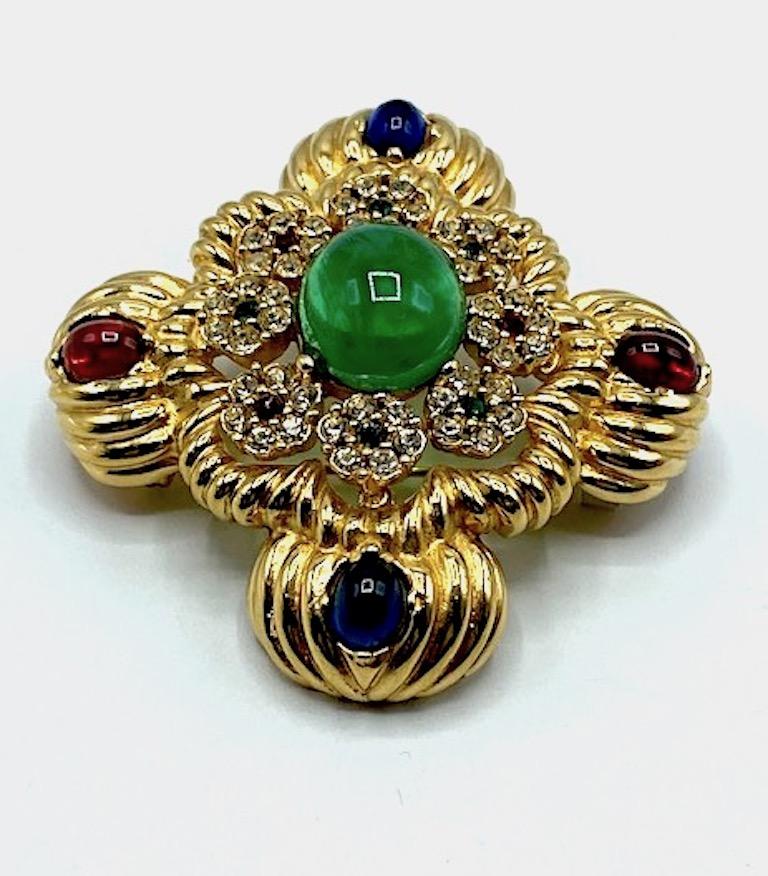 A stunning medallion brooch and pendant in the Mughal style by New York fashion jewelry company Ciner. Red, blue and green glass cabochons are set into a cast gold plate setting with rhinestone accents. The brooch and pendant is 2.38 inches in