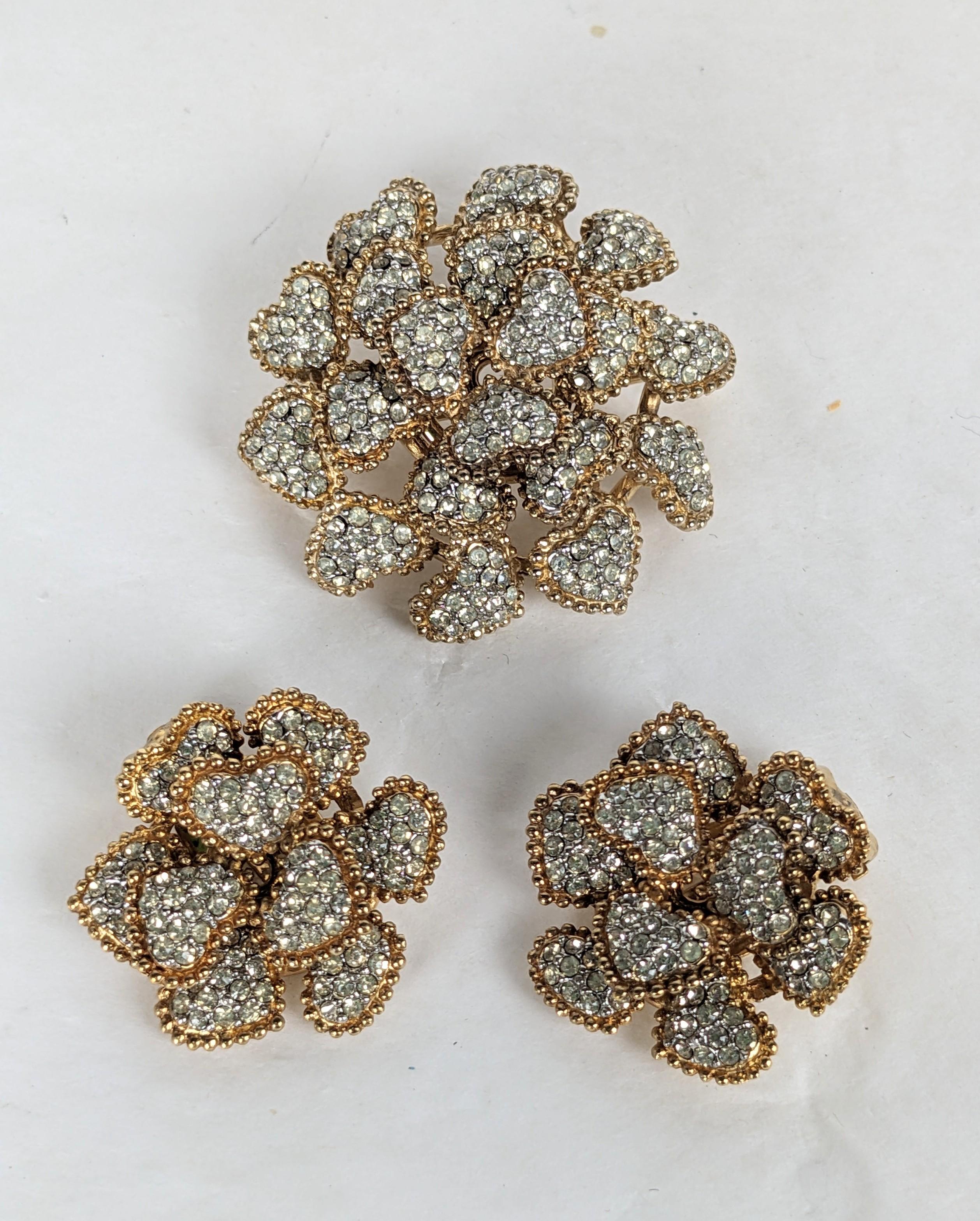 Elegant Ciner Pave and Gilt Flower Brooch Suite from the 1960's. Tiny heart shaped petals are hand pave set with crystals in gilt mounts. Brooch and clip back earrings. Signed. 1960's USA. 
Brooch 1.5