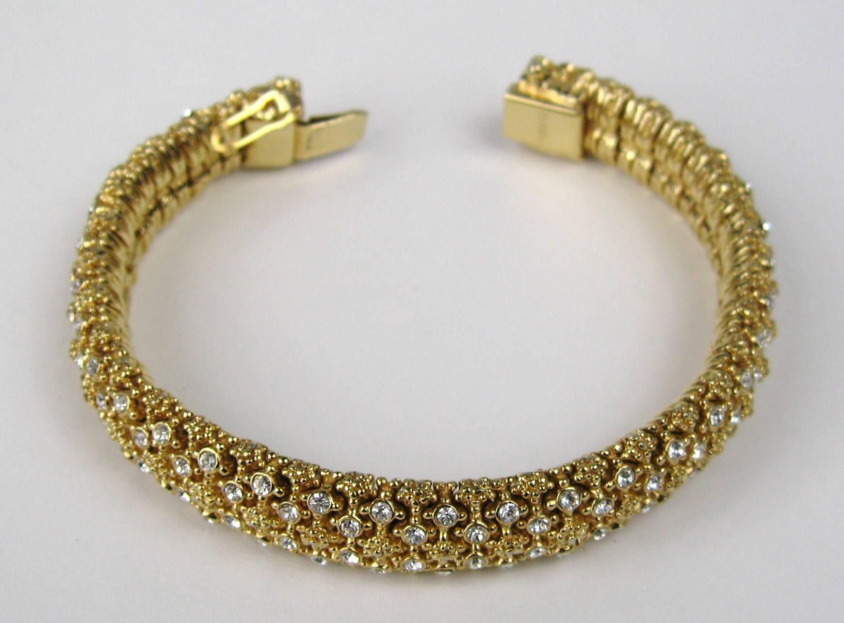 Ciner Gold gilt metal with stunning Swarovski Crystals. Measures . 7.25 inches end to end. will fit a 6.5 to 7 wrist. Matching Necklace listed as well. This is out of a massive collection of Contemporary designer clothing as well as Hopi, Zuni,