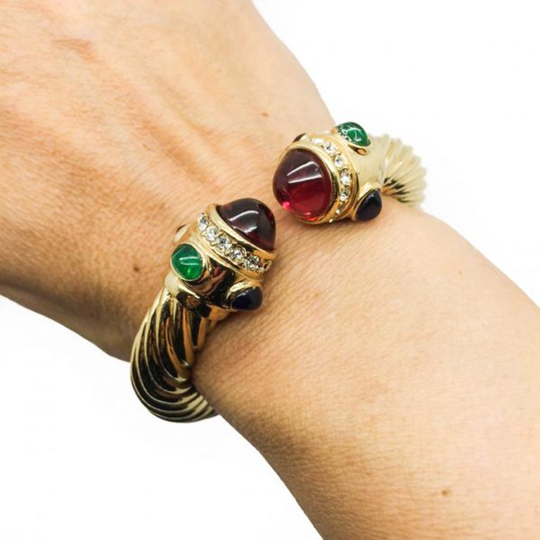 What a wonderful piece of Vintage Ciner Jewellery. This Vintage Ciner Bracelet dates to the 1990s, possibly the 1980s. Featuring a richly gold plated metal designed in a twist style clamper style bracelet, adorned with cabochon jewels and