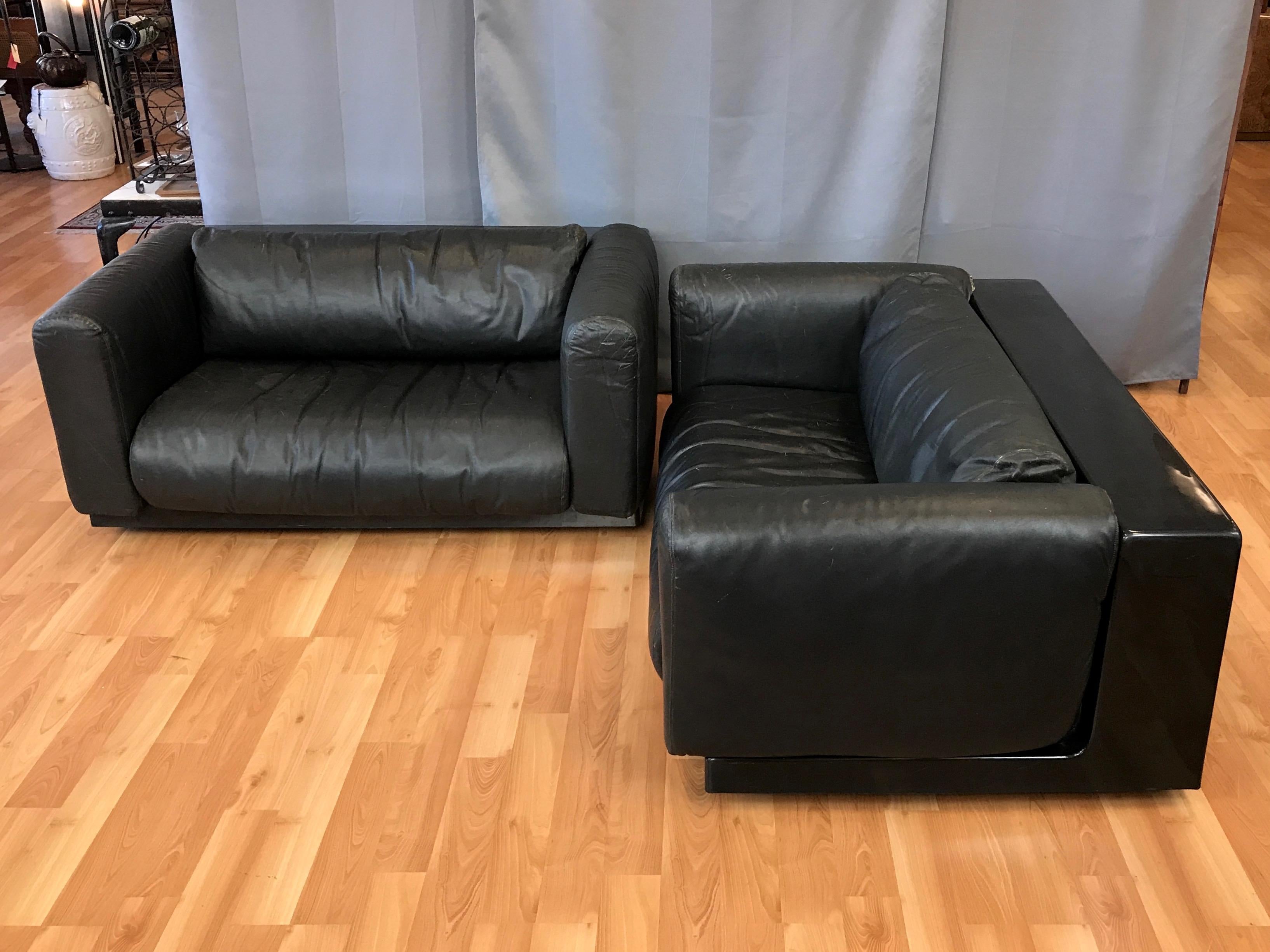 A pair of uncommon black leather and plastic gradual lounge small sofas or love seats by Cini Boeri for Knoll.

Molded black ABS plastic frame is equal parts 1960s mod and 1970s Futurist. Features a deep back with a spacious cubby measuring H 13