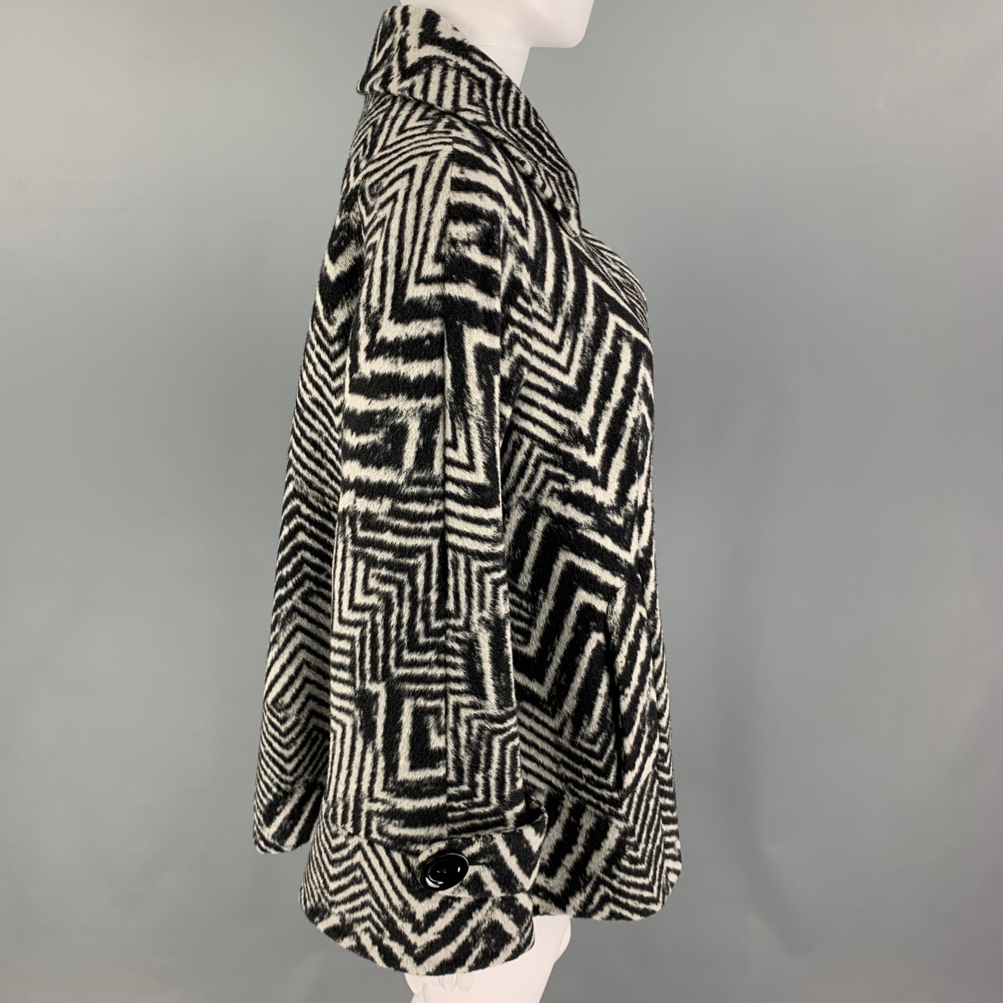 CINZIA ROCCA jacket comes in a black & grey zig zag angora blend featuring an a-line design, slit pockets, spread collar, and a buttoned closure. Made in Italy. 

Excellent Pre-Owned Condition.
Marked: IT 44 / USA 8 / D-CH 38 / F 40 / GB