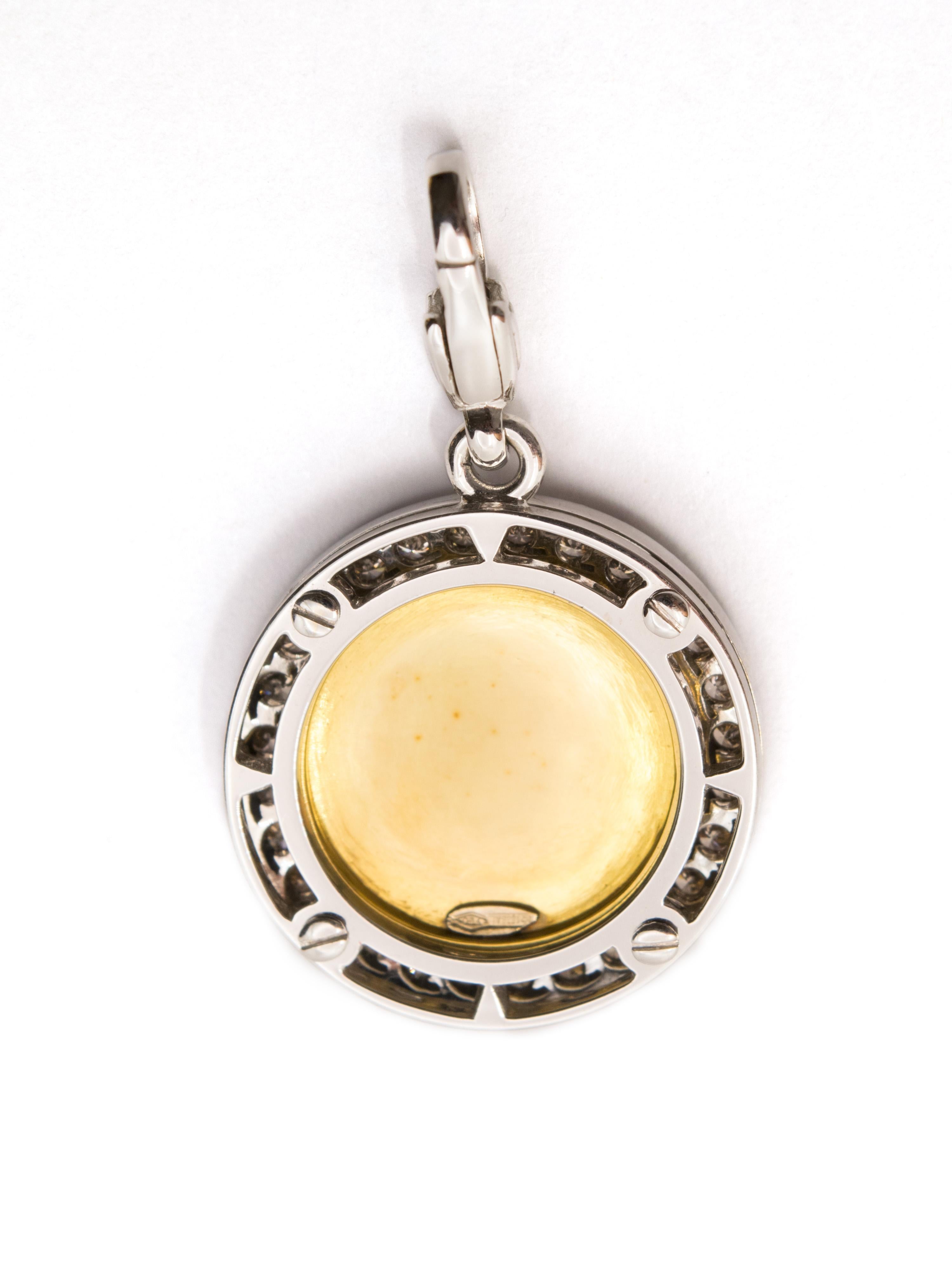 A beautiful pendant in 18kt gold , white gold in the front and yellow gold in the back.
This lucky charm has the number 13 in gold and white diamonds ( ct 0.32 ) set on a black enamel ( fire enamel ) base and a round brown diamond ( ct 0.68 )