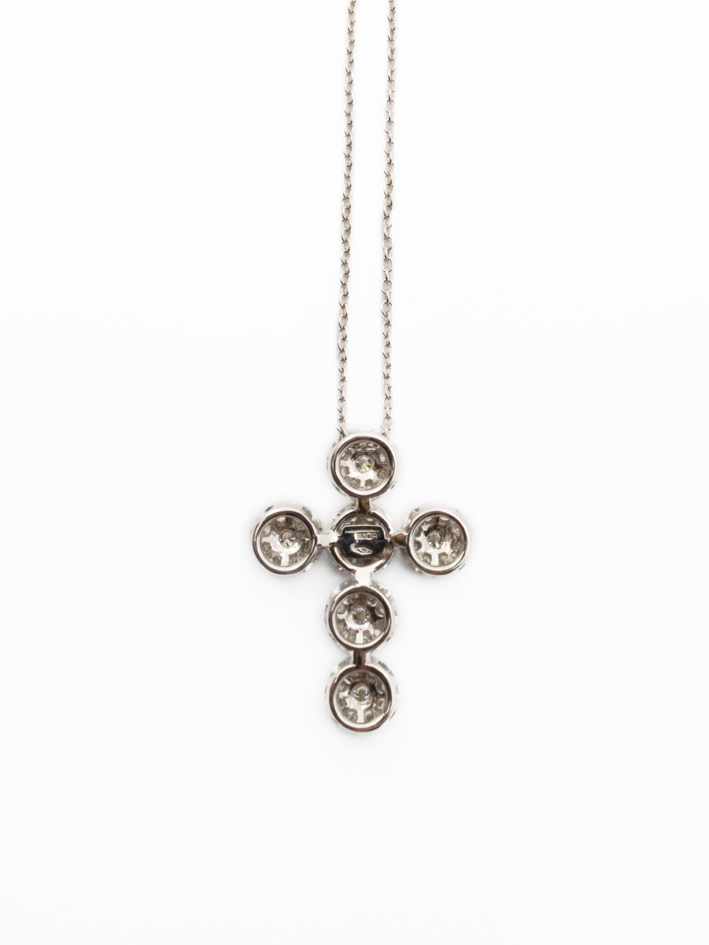A beautiful cross pendant with chain loop.
This jewelry is made of 18 kt white gold and has a total weight of 8.25 grams.
The cross consists of six bezels  of diamonds, each of which has a larger size diamond in the center.
The total weight of the