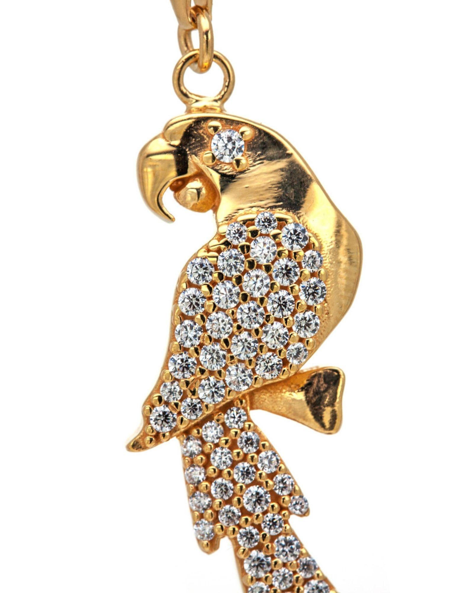 This parrot-shaped pendant is a representation of the beauty of nature in an elegant and refined key.

The parrot pendant has a snap hook that allows it to be detached and worn on any chain, made of 925 gold-plated sterling silver and studded with