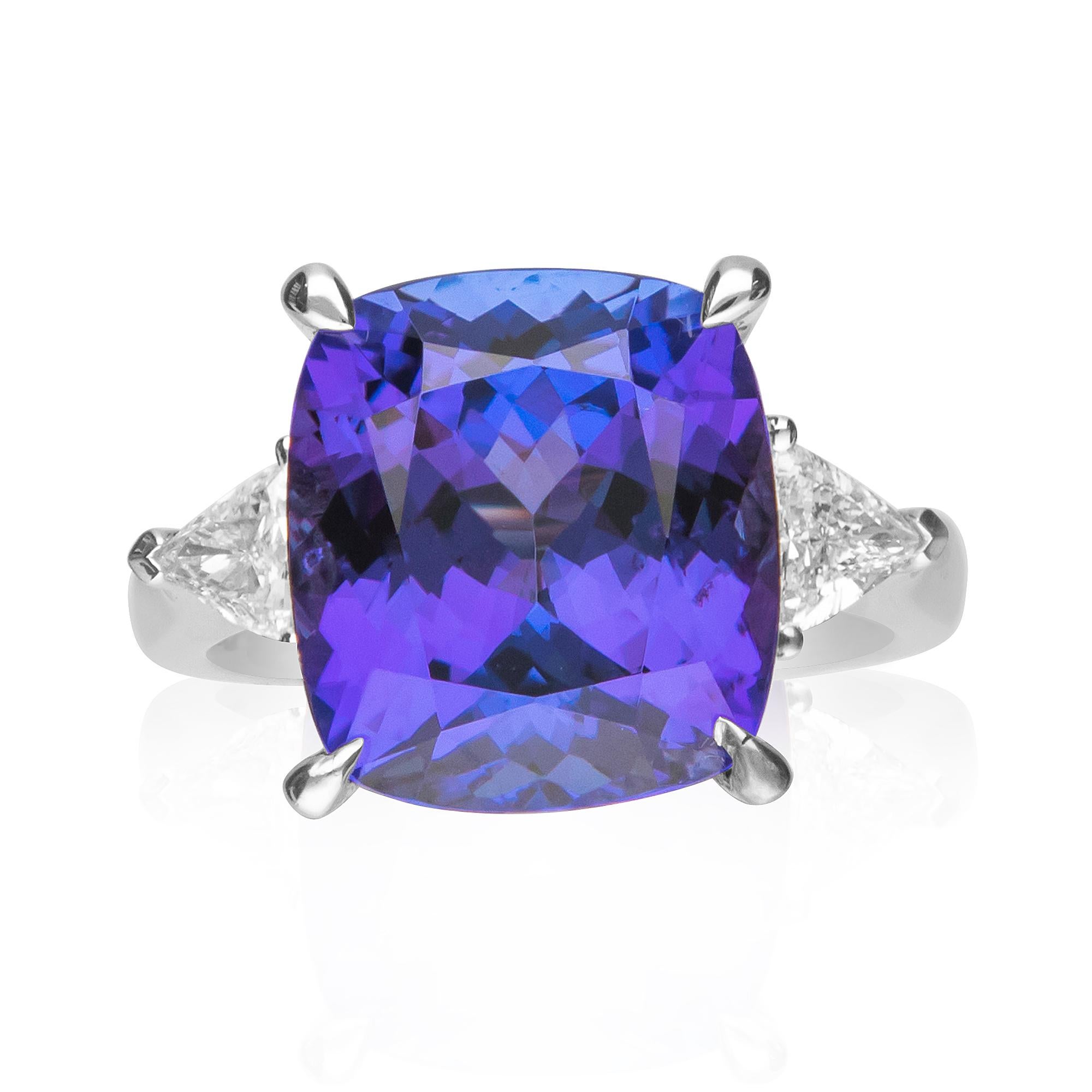 This classic engagement ring is crafted in 18-karat White gold and features an 11.35 Carat Cushion cut Tanzanite and 2 Trillion cut Diamonds 0.51 Ct. GH- SI quality. This ring comes in size 7 and is a perfect gift either for yourself or someone you