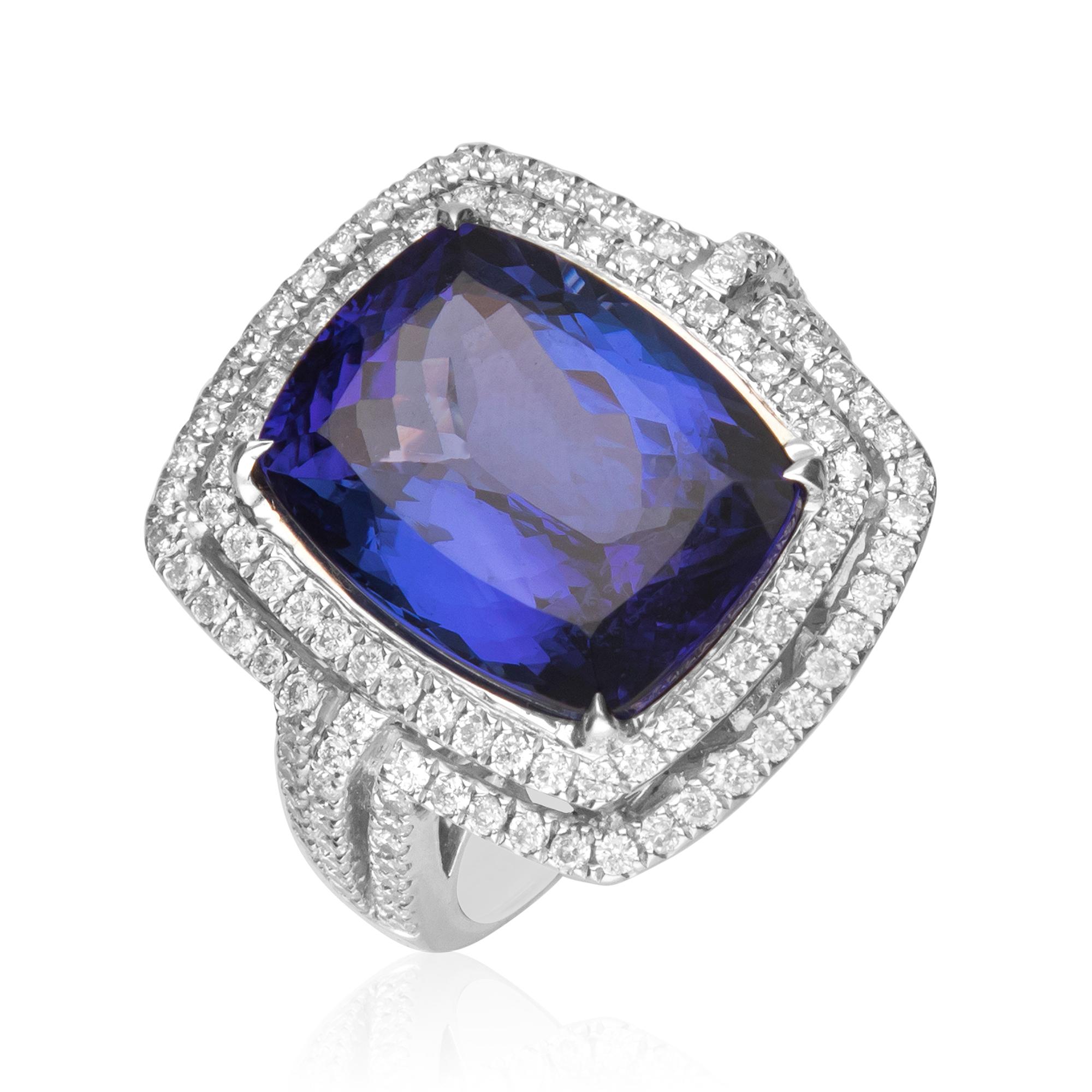 This unique designer engagement ring is crafted in 18-karat White gold and features a Cushion cut 12.64 Carat Tanzanite 12x15 mm and surrounded by 136 Round Diamonds 1.08 Ct.  GH- SI quality in a prong-setting. This ring comes in size 7 and is a