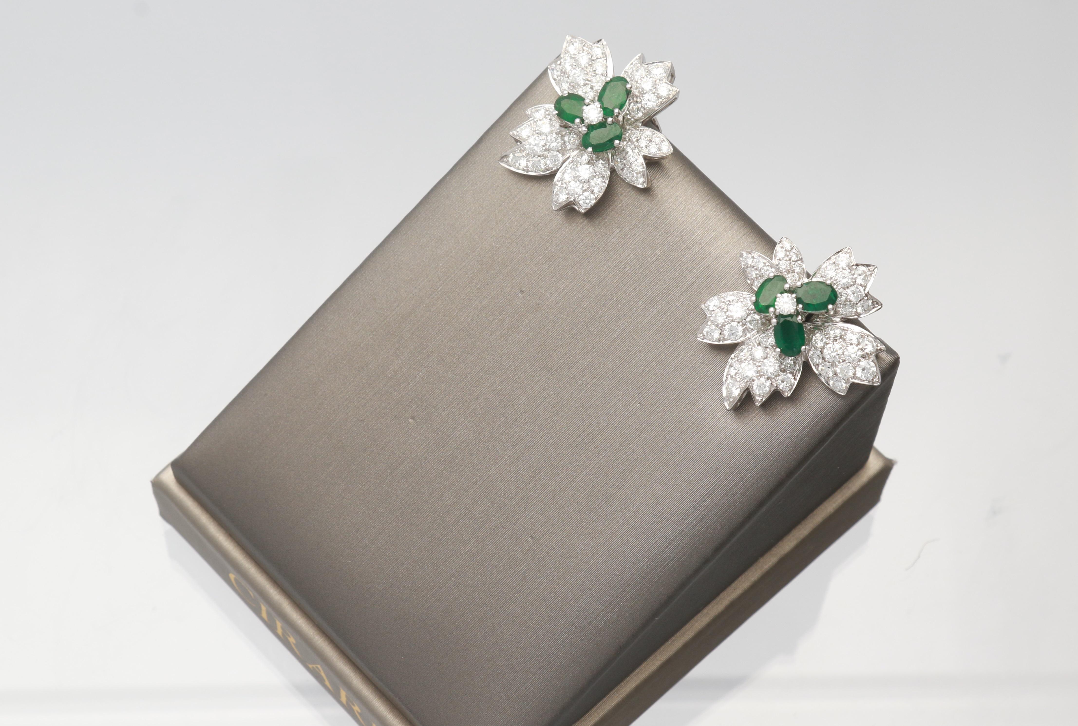 This one of a kind Earring is crafted in 18-karat White Gold and features six oval cut Emeralds 2 9/10 Carat, 2 Brilliant cut Round Diamonds 0.18 carat & 100 Brilliant cut Round Diamonds 4 1/8 Carat. This earring is secured with omega backs and it