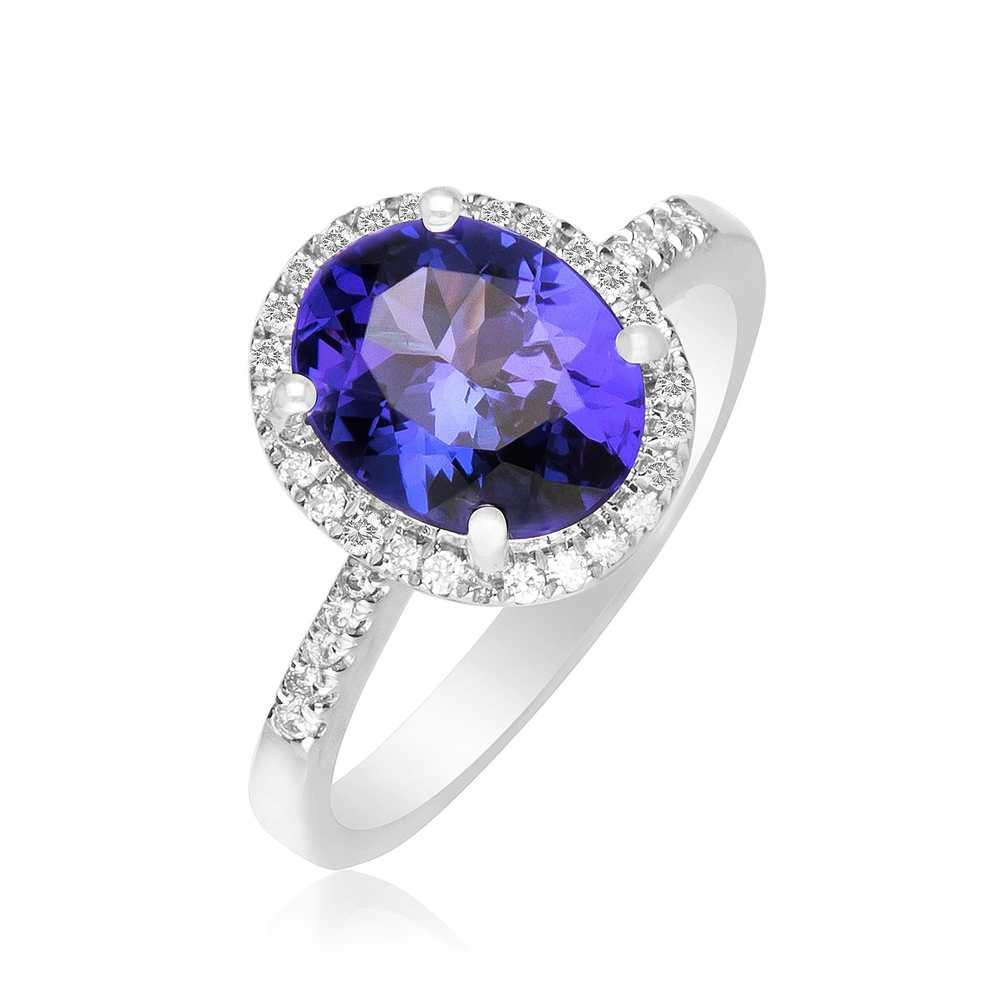 This elegant engagement ring is crafted in 14-karat White gold. It features an oval cut 2.42 Carat Tanzanite 8x10 mm and 40 Round Diamonds 1/5 Ct. GH SI2 quality in a prong-setting. This ring comes in size 7 and is a perfect gift either for yourself