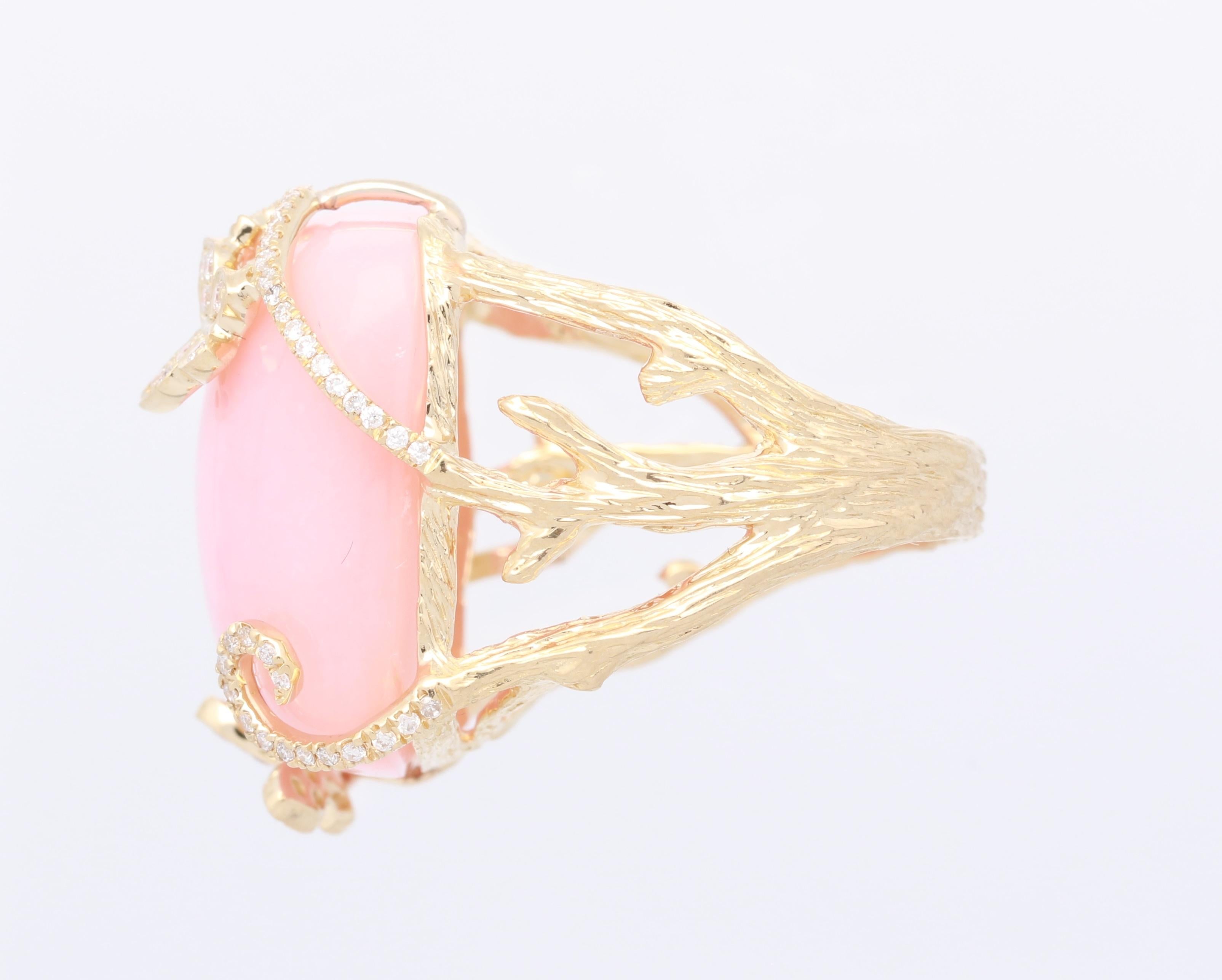 Showcase your unique style with our Cirari pink opal and diamond one of a kind ring crafted of 14k yellow gold. This ring features a cushion shaped 25 1/5 carat Pink opal cut and 1/3 carat of glistening diamonds with a butterfly design that holds