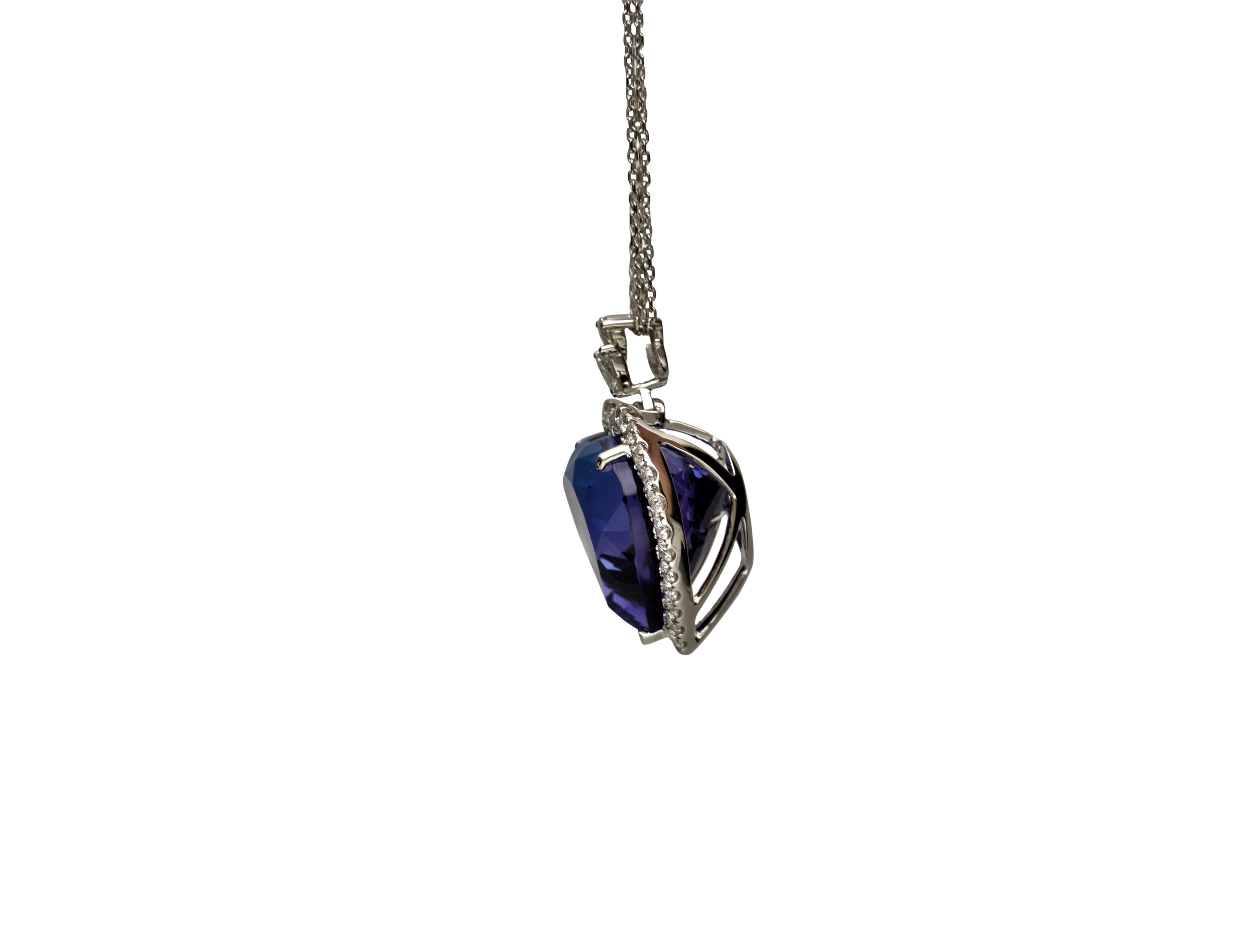 This beautiful Heart Necklace is crafted in 18-karat White gold. It features a 19 mm Heart Shaped Tanzanite 31.83 Carat, 2 Marquise Diamonds 0.29 ct., 1 Pear Shape Diamond 0.18 Carat GH-SI quality, and surrounded by 30 Round Diamonds 1.04 Carat.