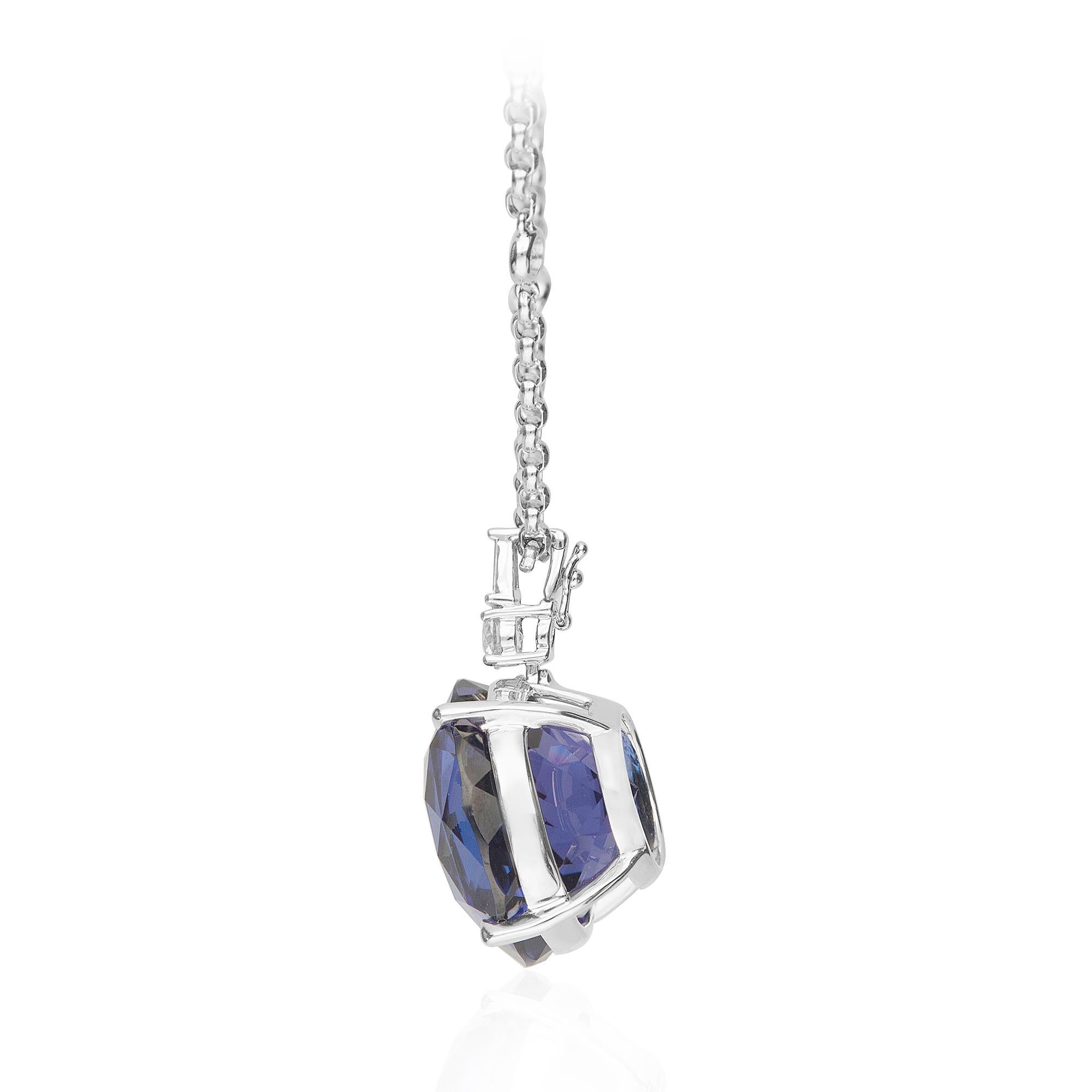 This beautiful pendant Necklace is crafted in 18-karat White gold. It features a 20.5 mm round Tanzanite weighing 44.73 Carat, 9 brilliant cut round diamonds 1.17 ct., and 2 Baguette diamonds 0.19 ct. GH-SI quality. 

This necklace comes with 18k